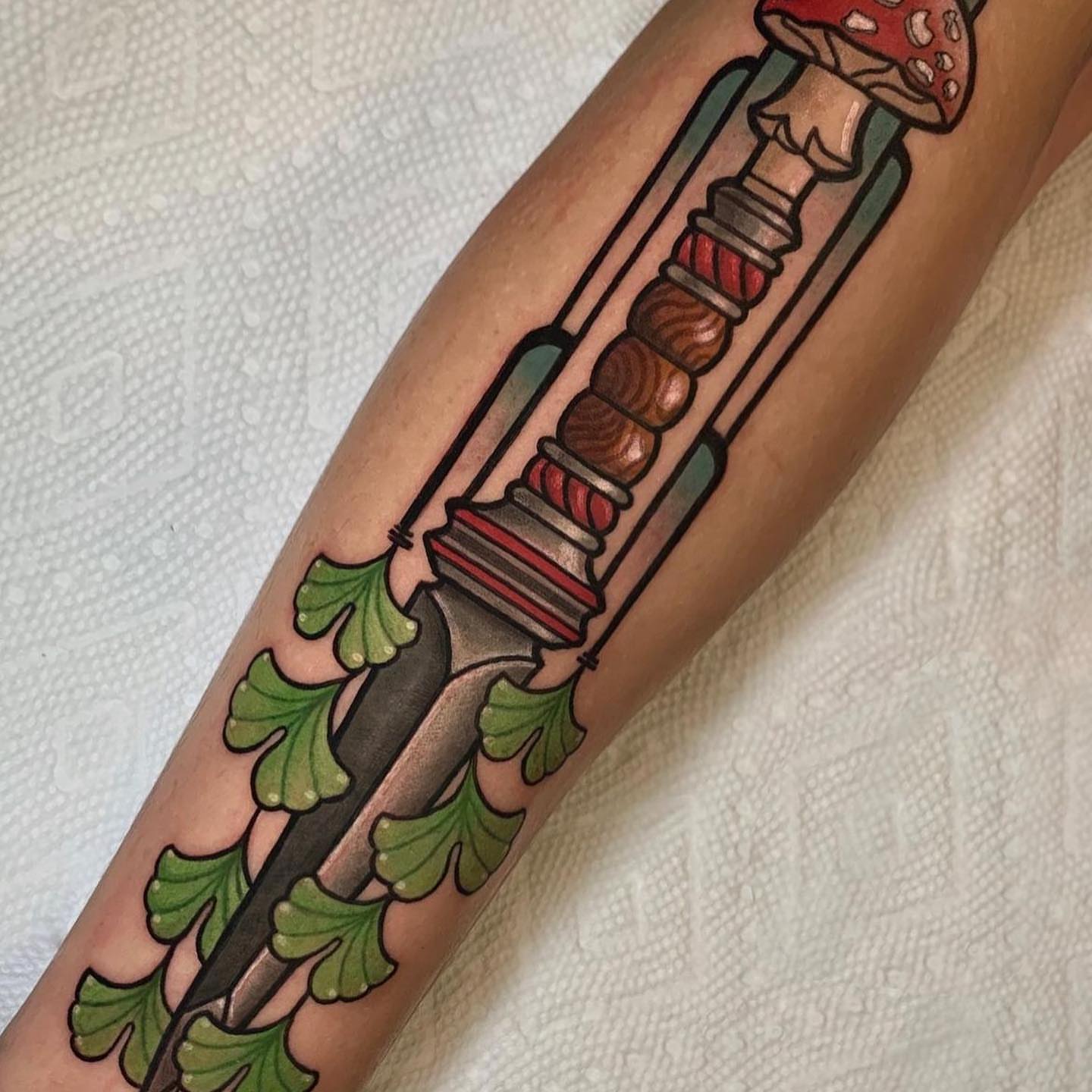 Mushroom and knife American traditional tattoo on the forearm by Cortney Norton
