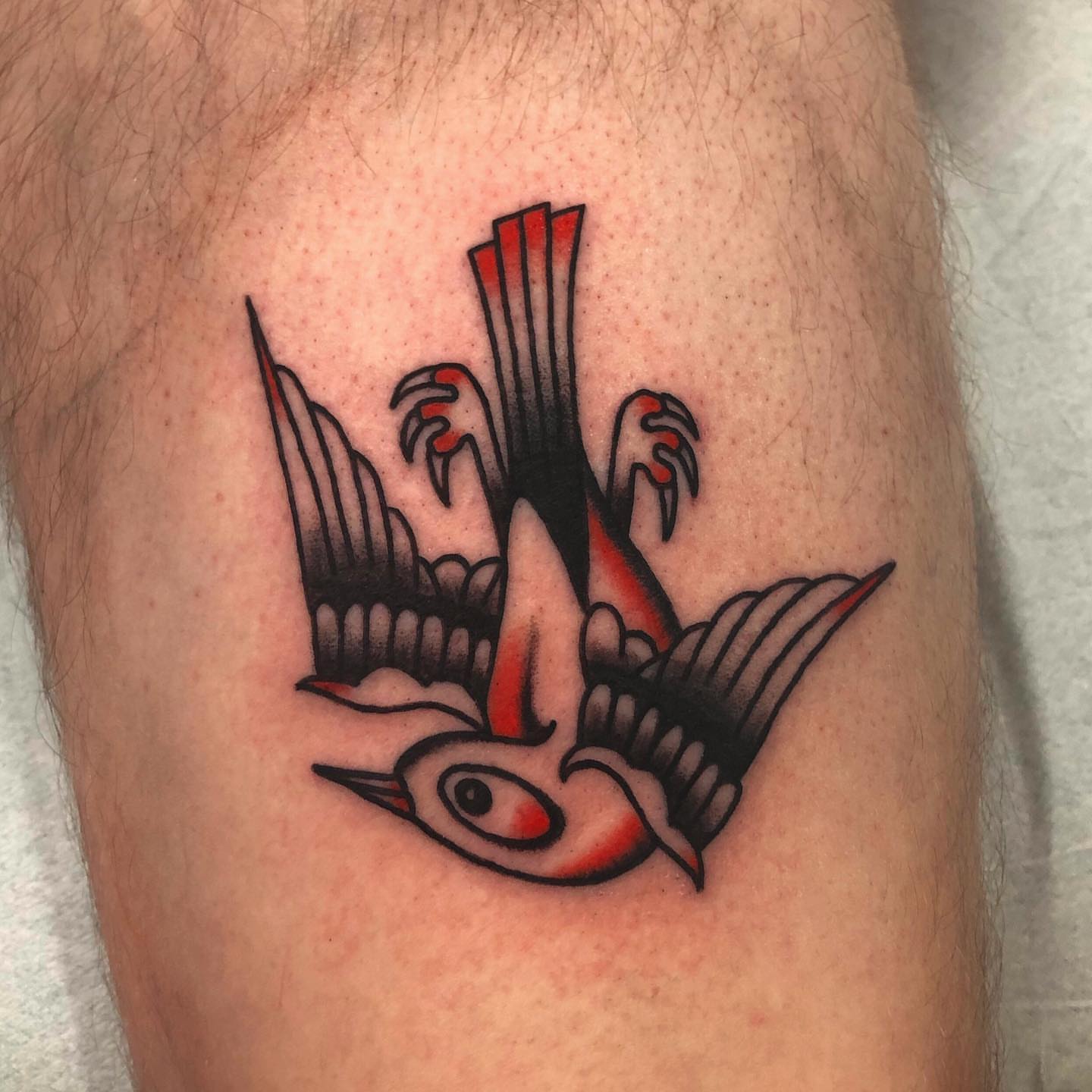 Swallow American traditional tattoo on the thigh by brenden