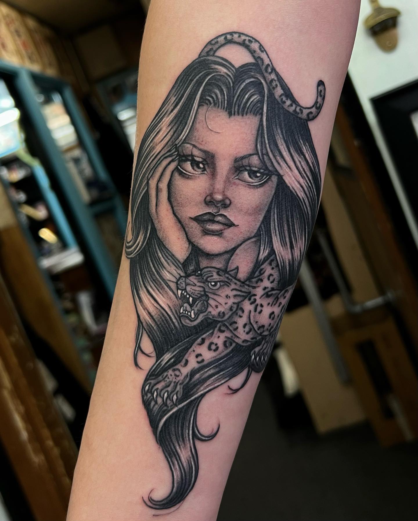 Woman with leopard realism tattoo on the forearm by Valerie Dominguez