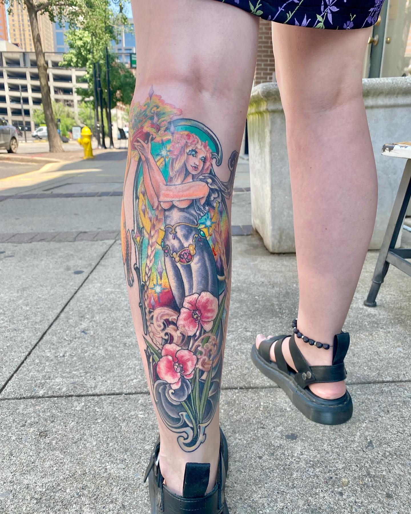 Mermaid and flowers new school tattoo on the calf by Christopher Sanders