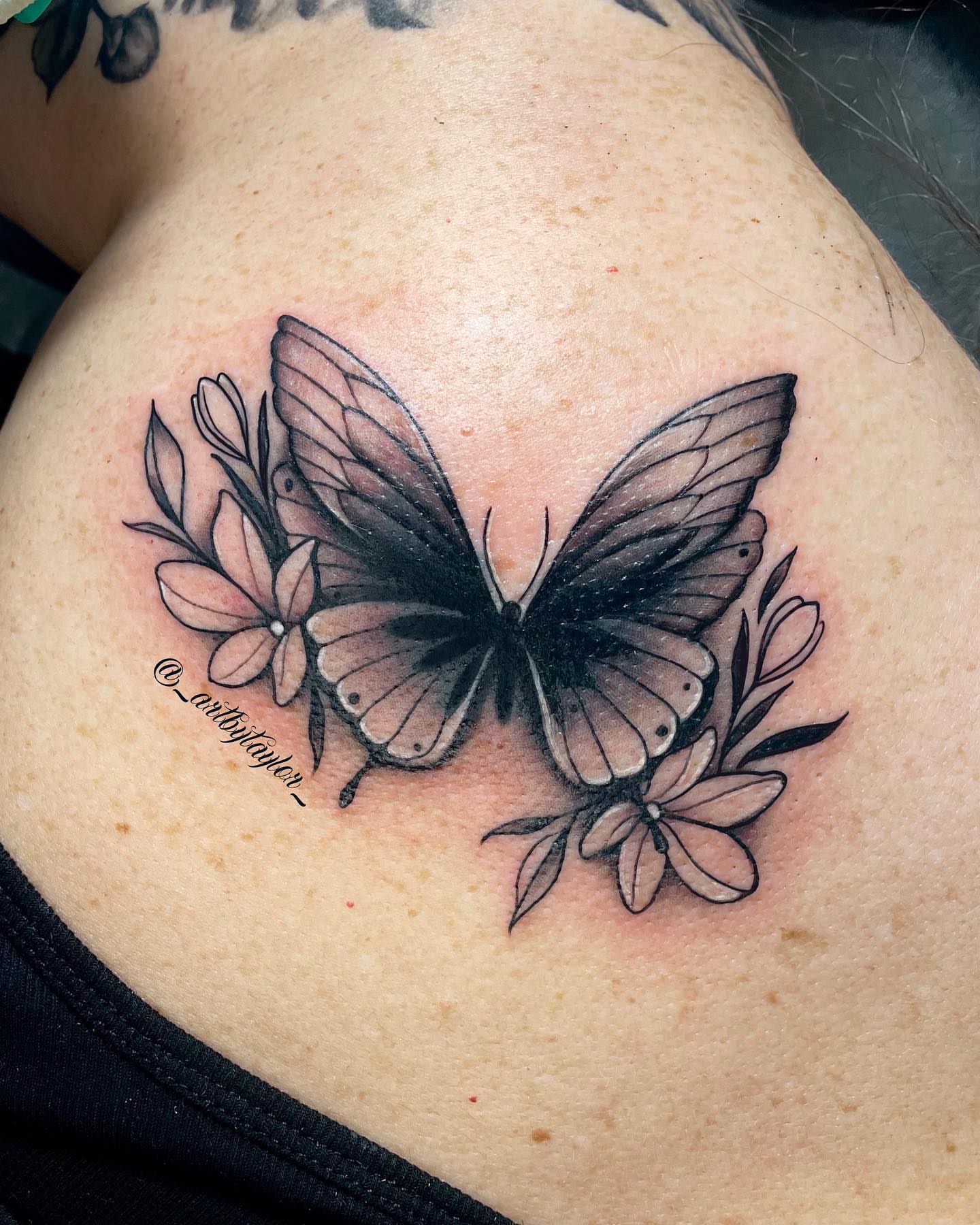 Butterfly and flowers black and grey tattoo on the chest by Taylor✍🏽️