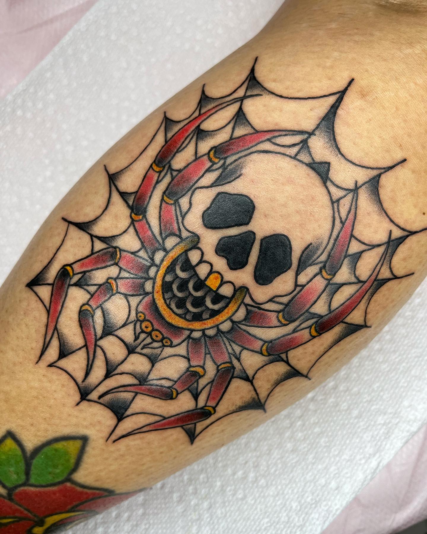 Skull and spiderweb American traditional tattoo on the forearm by Pedroux M.