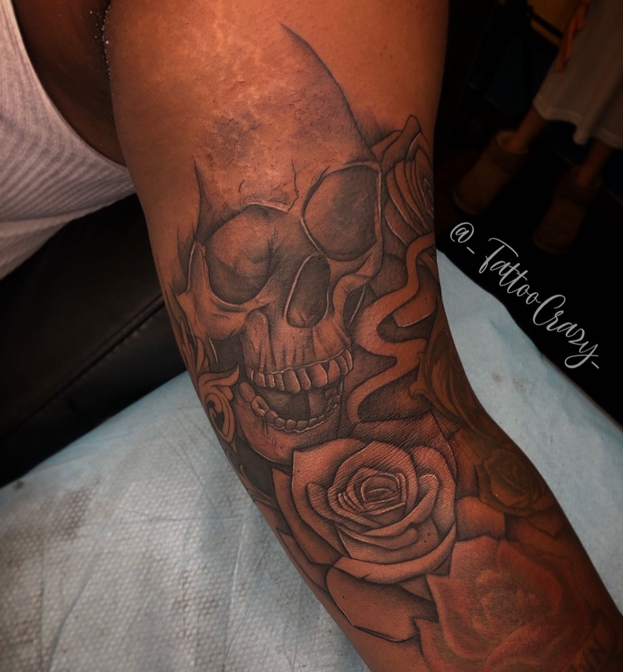 Skull and roses realism tattoo on the forearm by TattooCrazy🎭