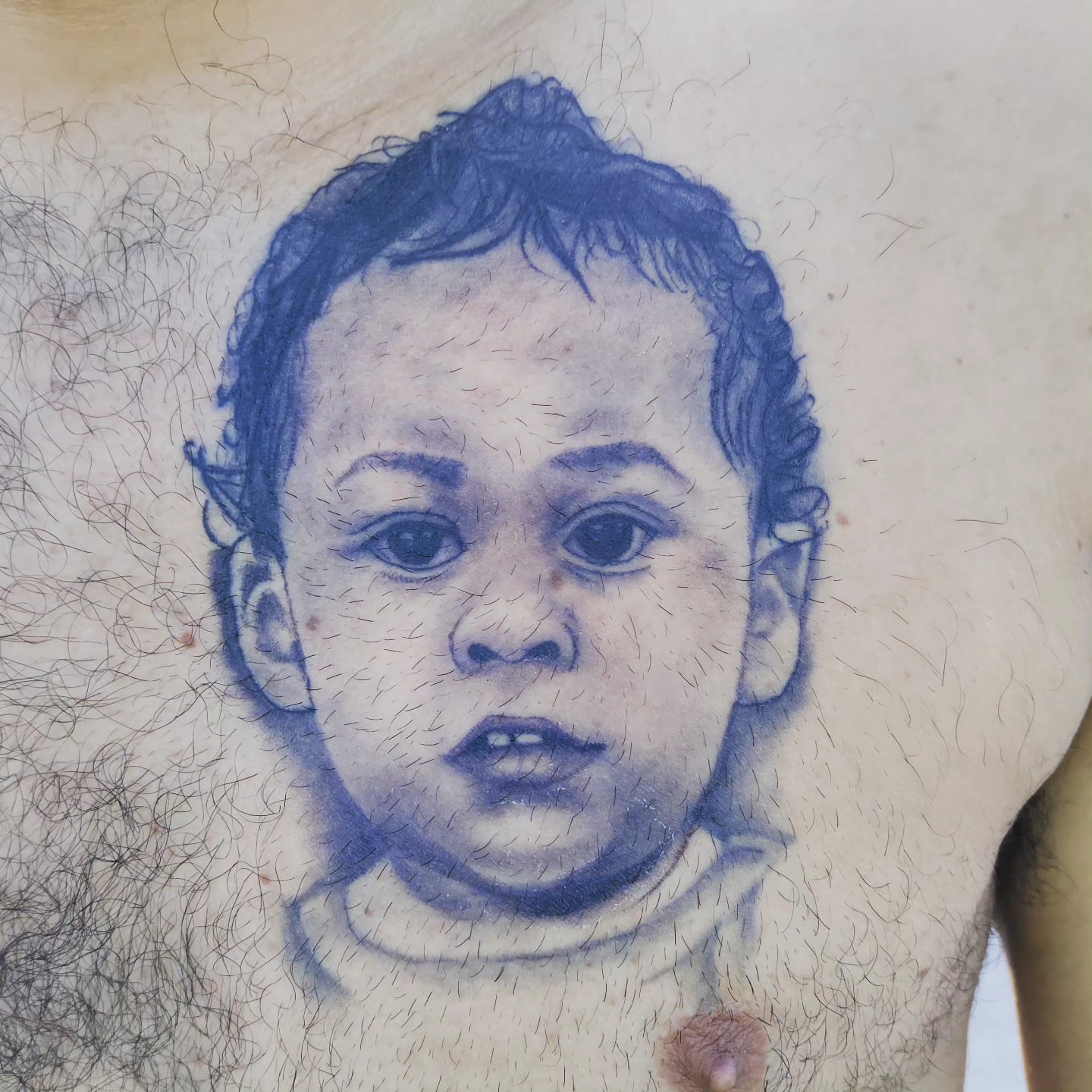 Baby portrait realism tattoo on the chest by Noriega Josué