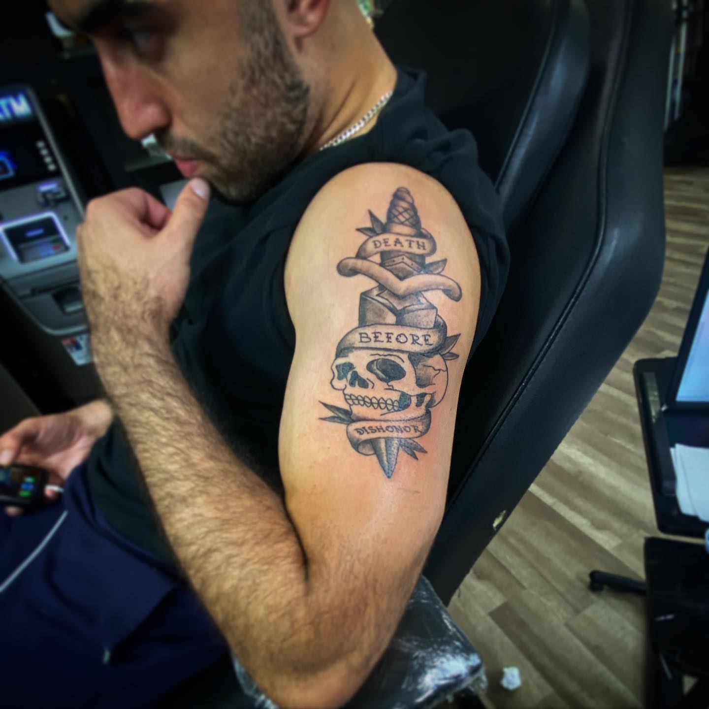 Skull and dagger black and grey tattoo on the forearm by Erasmo Vasquez