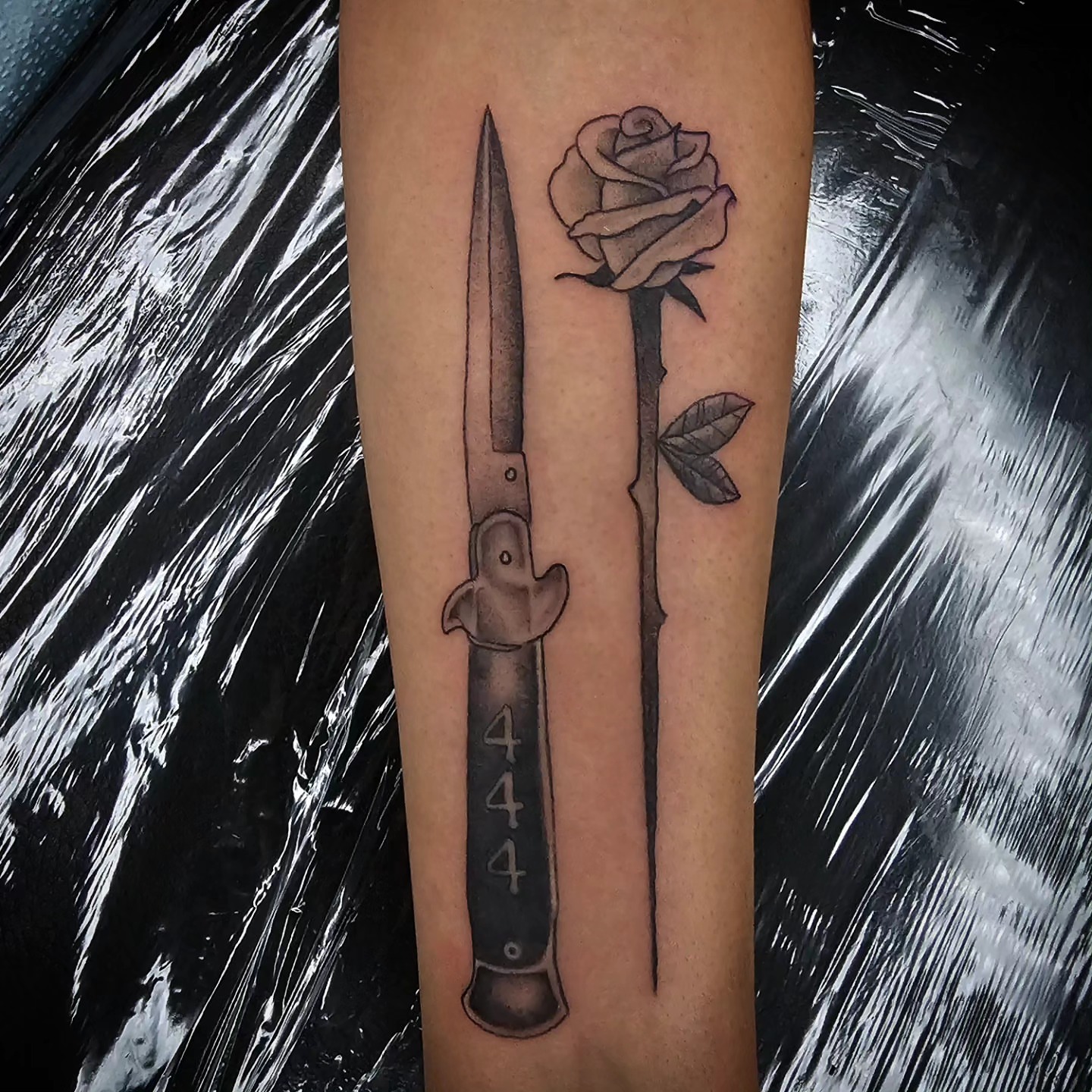 Knife and rose realism tattoo on the forearm by TattoosbyPhatboi