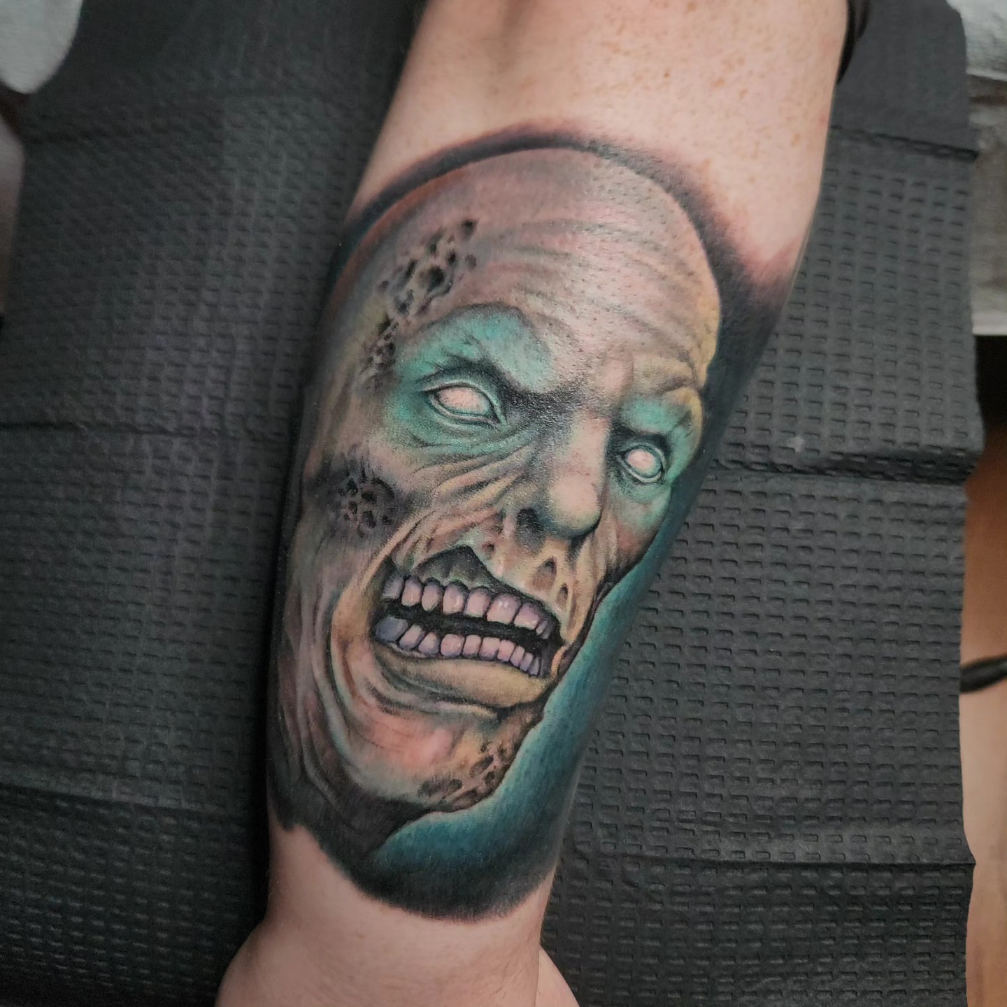 Zombie face realism tattoo on the forearm by Don Taylor
