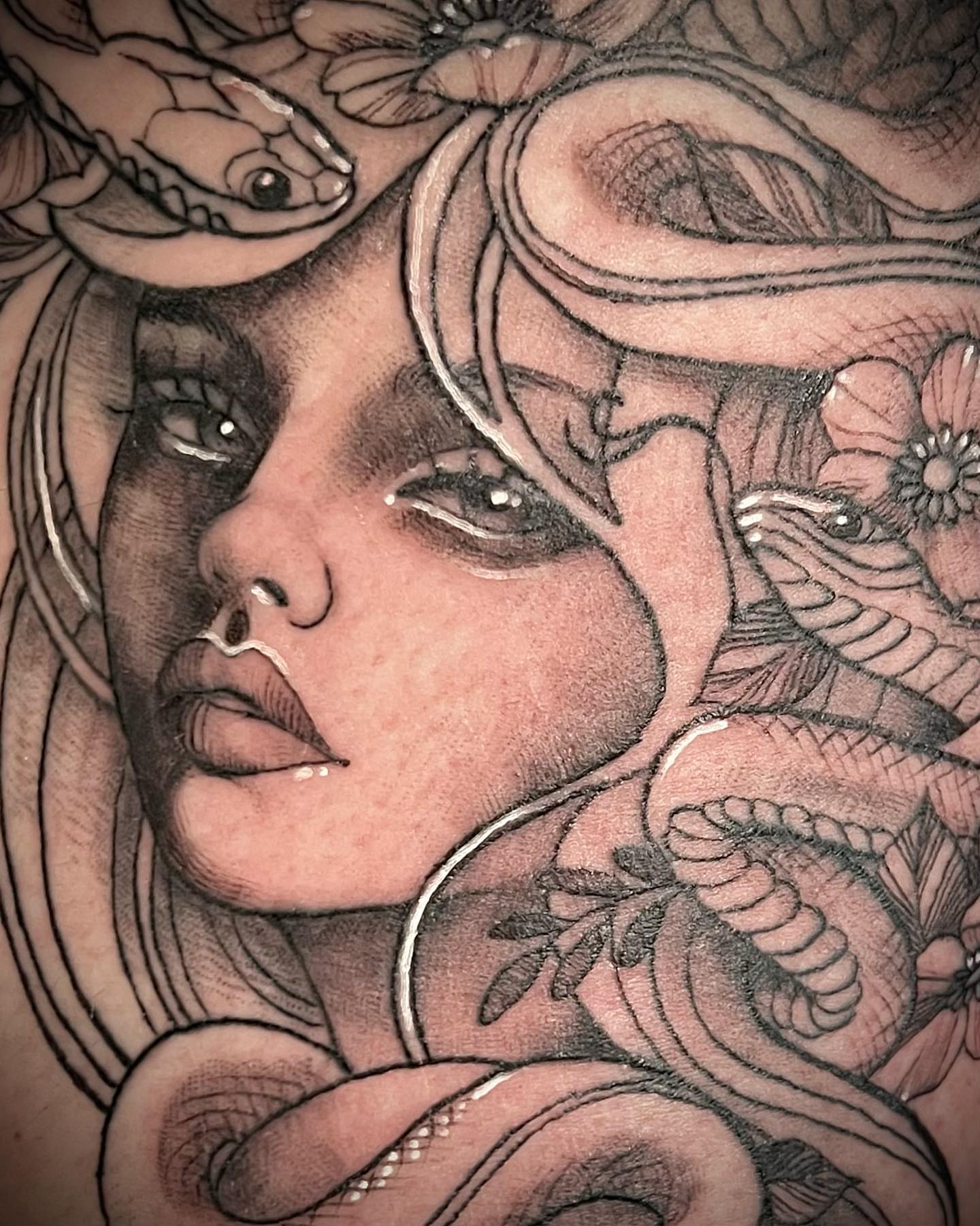 Woman's face with snakes realism tattoo on the torso by Tattoos by Alli Wilcox