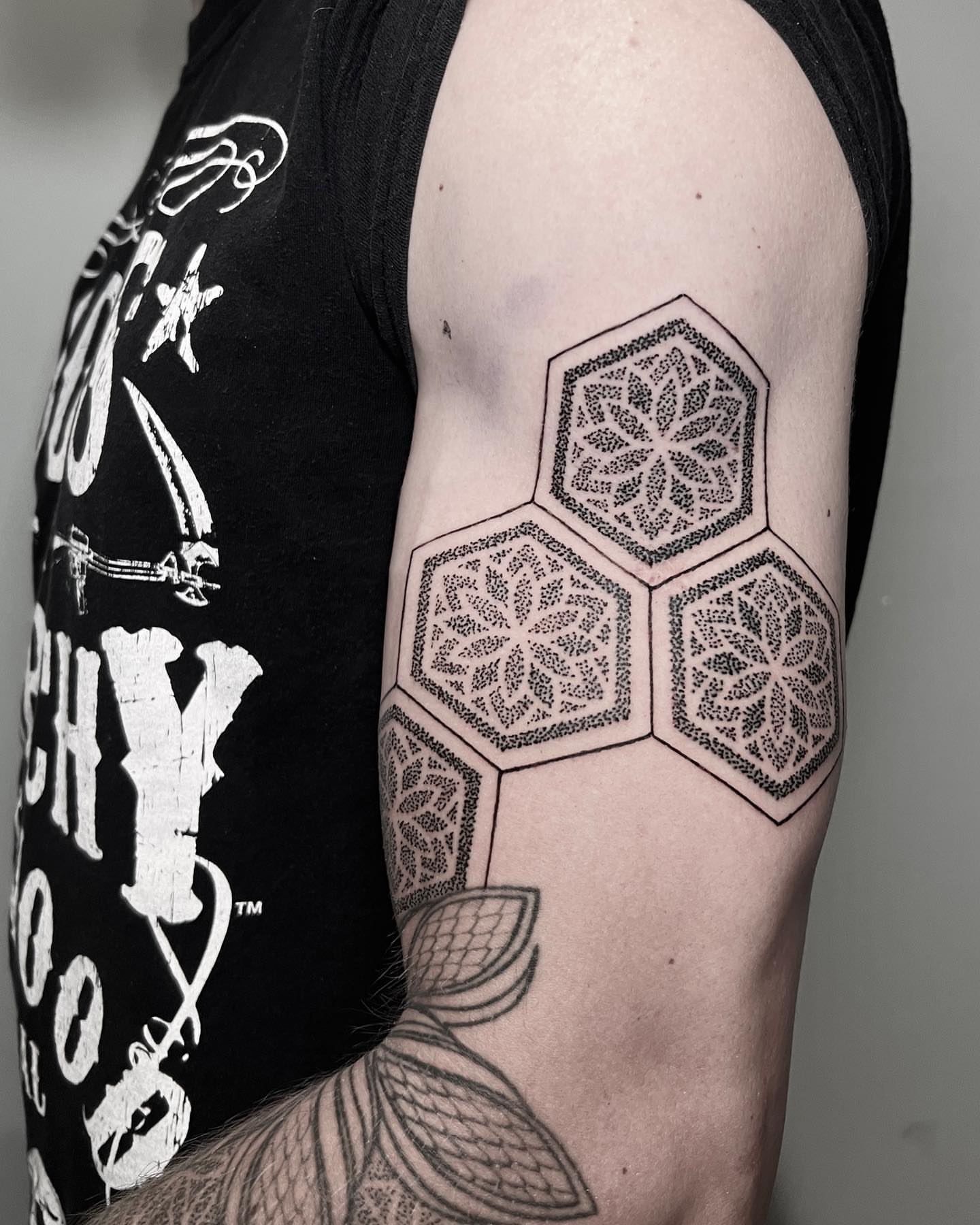 Hexagonal pattern dotwork tattoo on the forearm by Alex Shakuto Tattoo