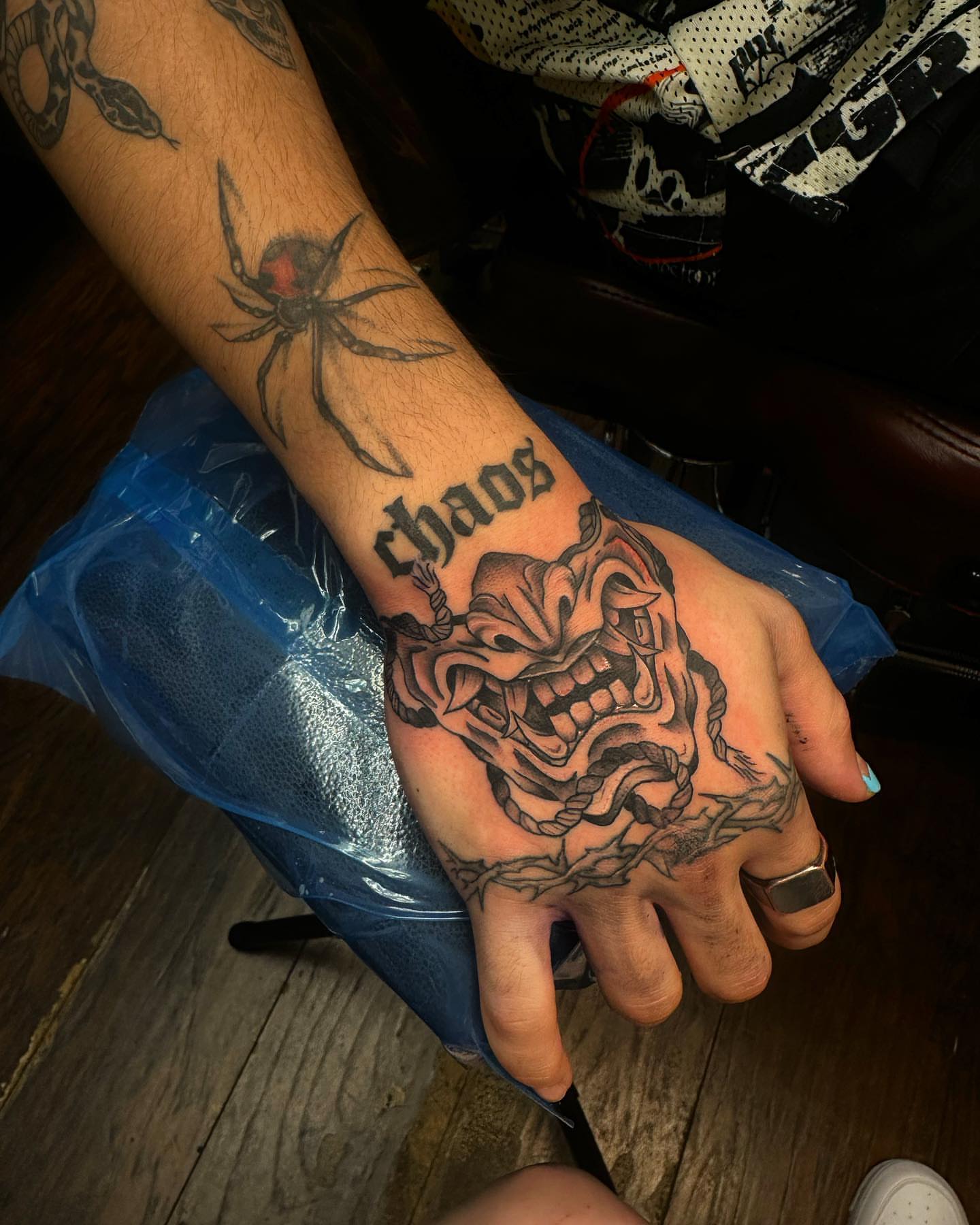 Demon mask American traditional tattoo on the hand by Kassie Perian