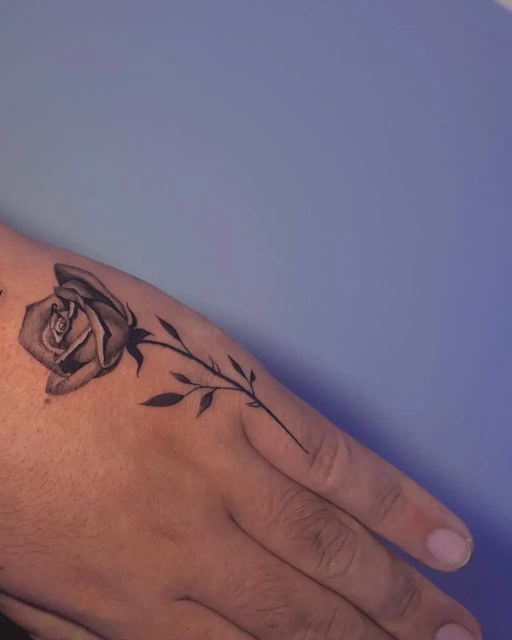 Rose black and grey tattoo on the hand by Amilia Gullotta