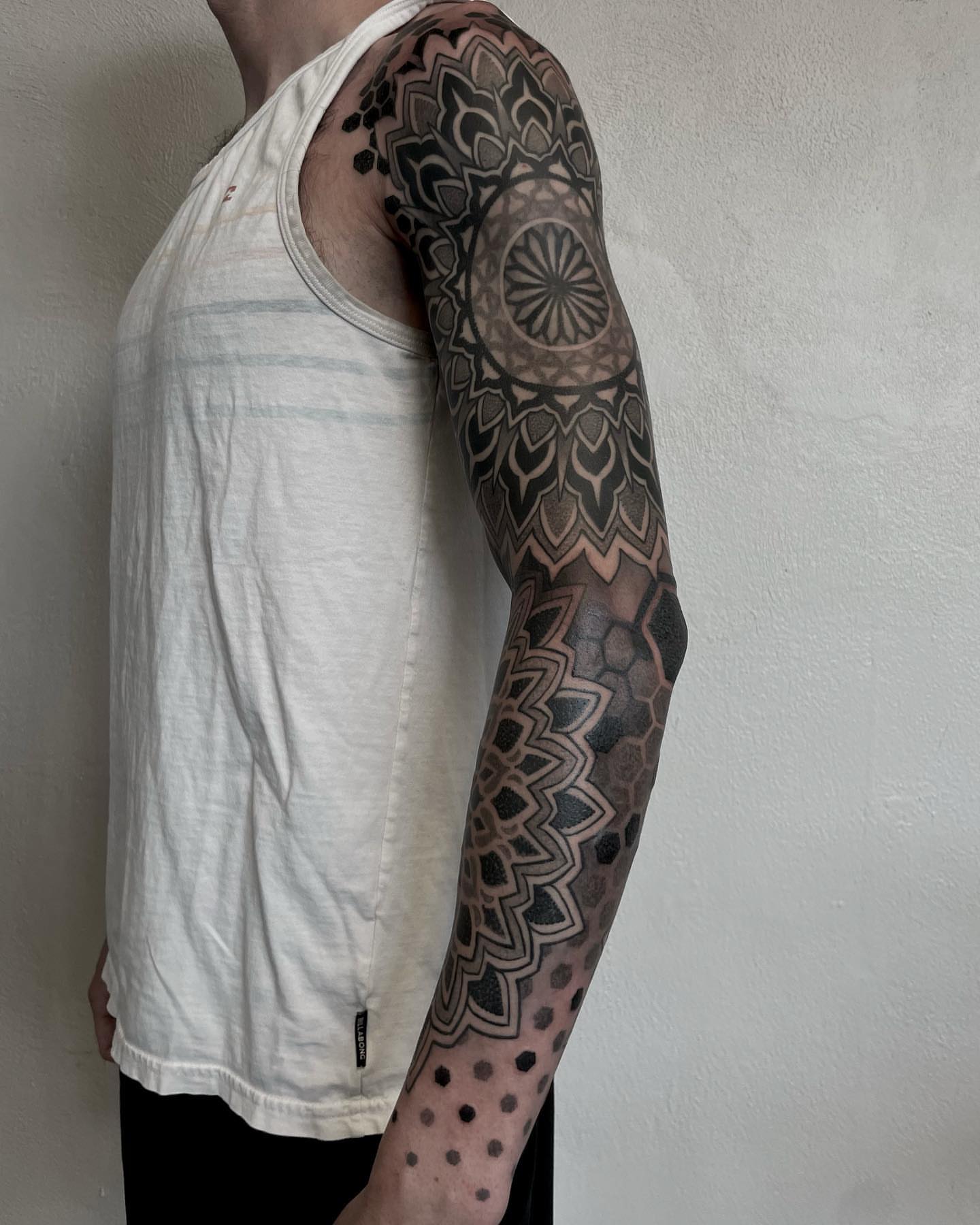 Geometric mandala dotwork tattoo on the forearm by gina