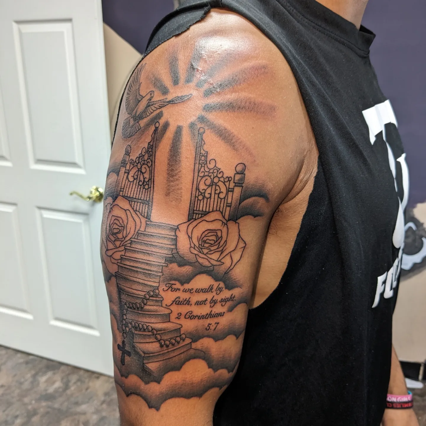 Staircase with roses realism tattoo on the shoulder by Kara Falcon