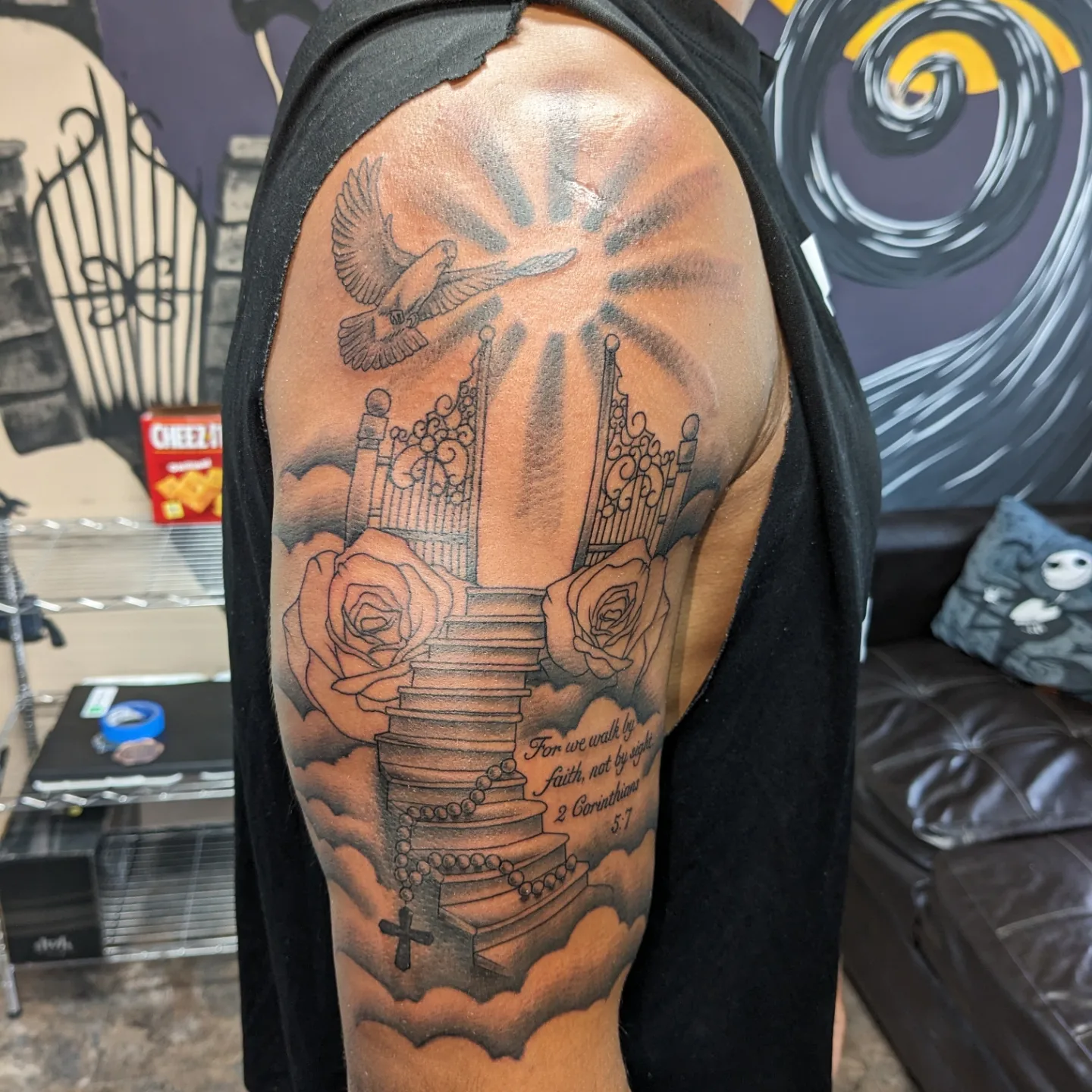 Religious staircase realism tattoo on the upper arm by Kara Falcon