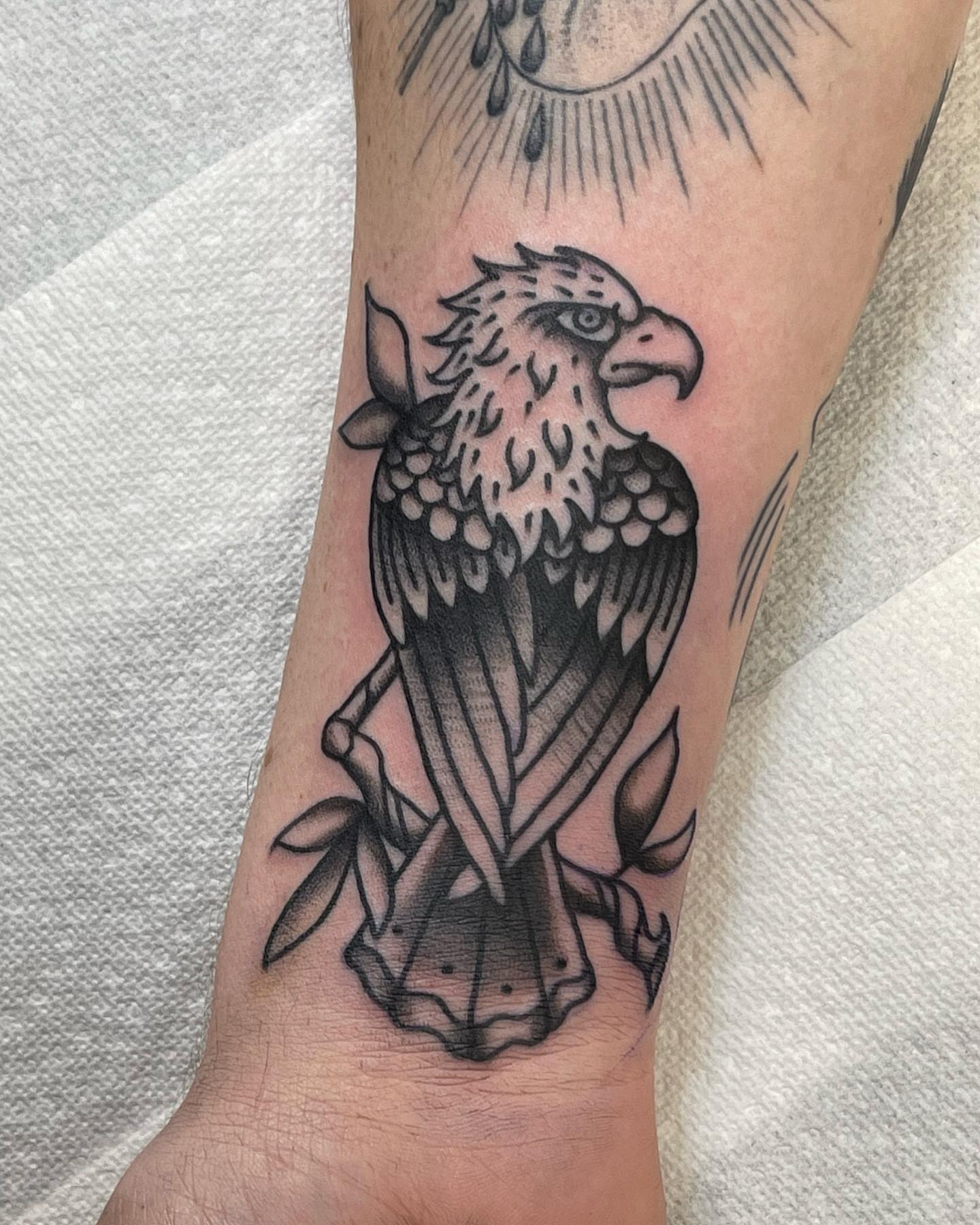 Eagle black and grey tattoo on the forearm by Dave Shurman