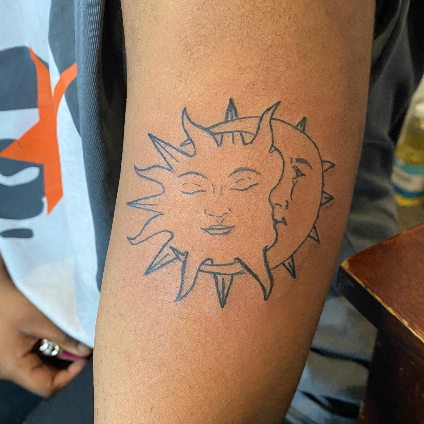 Sun and moon faces black and grey tattoo on the forearm by ๐ฆ