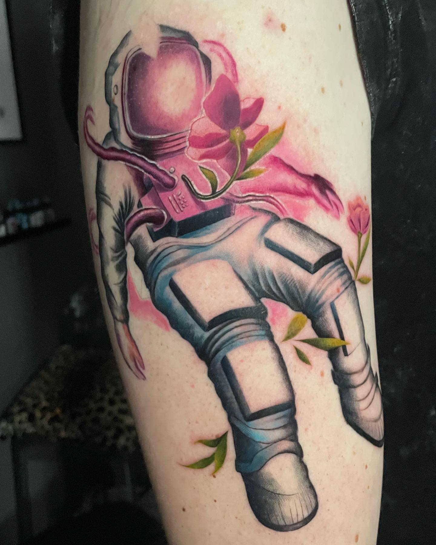 Astronaut with flowers realism tattoo on the forearm by @doctorze