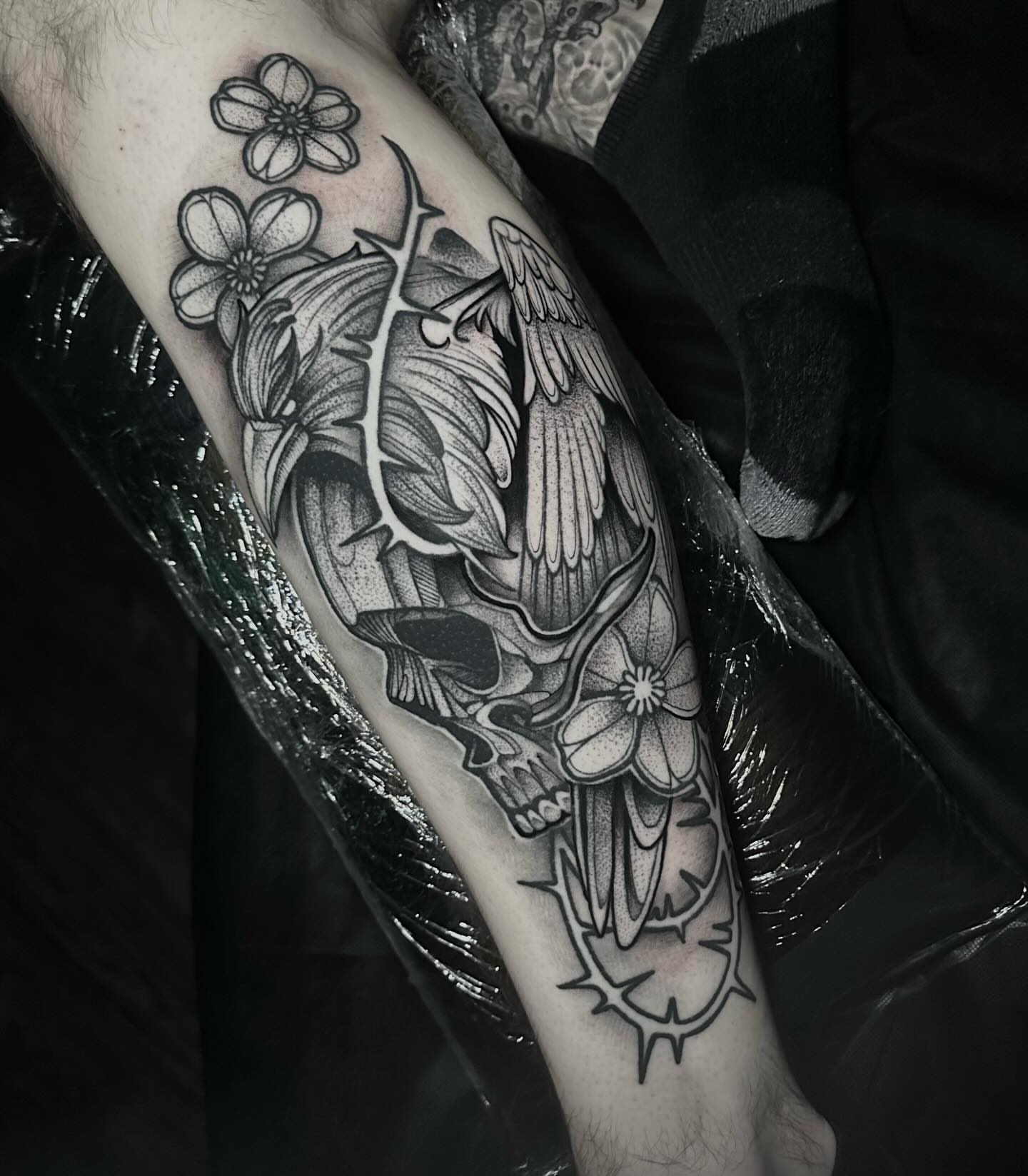 Skull with flowers dotwork tattoo on the forearm by Clayton Smith (BEAR)