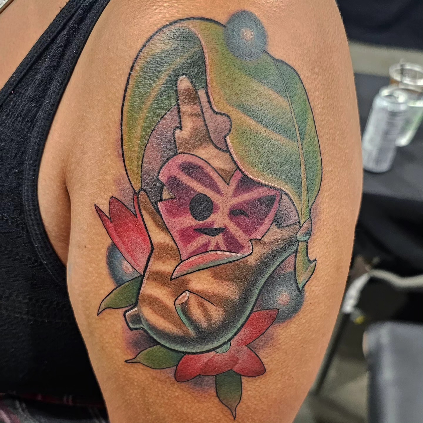Mask with flower American traditional tattoo on the thigh by Gabrielle Nicole Soucie