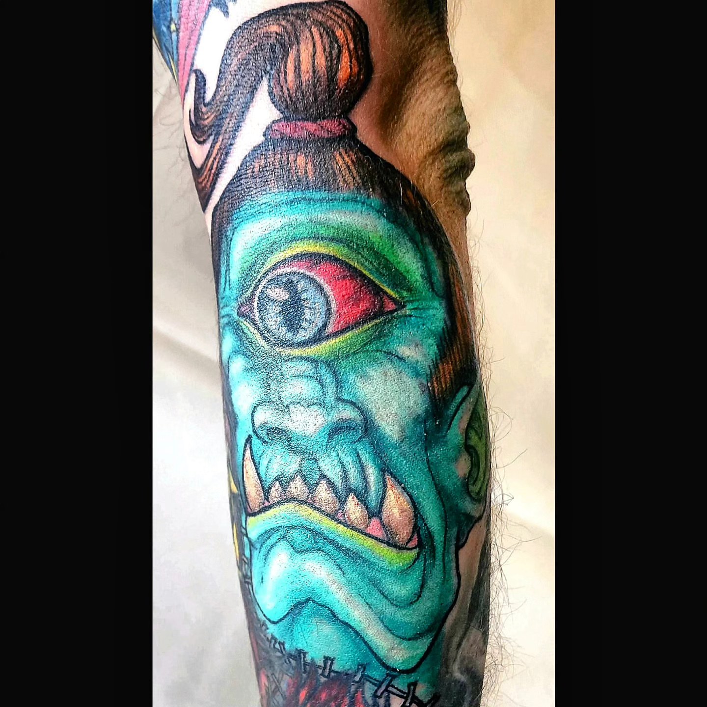 Monster head realism tattoo on the forearm by Scott Fricke