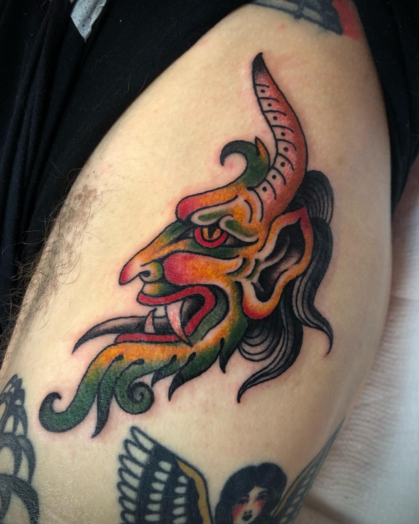 Mask American traditional tattoo on the thigh by Paul Trimble