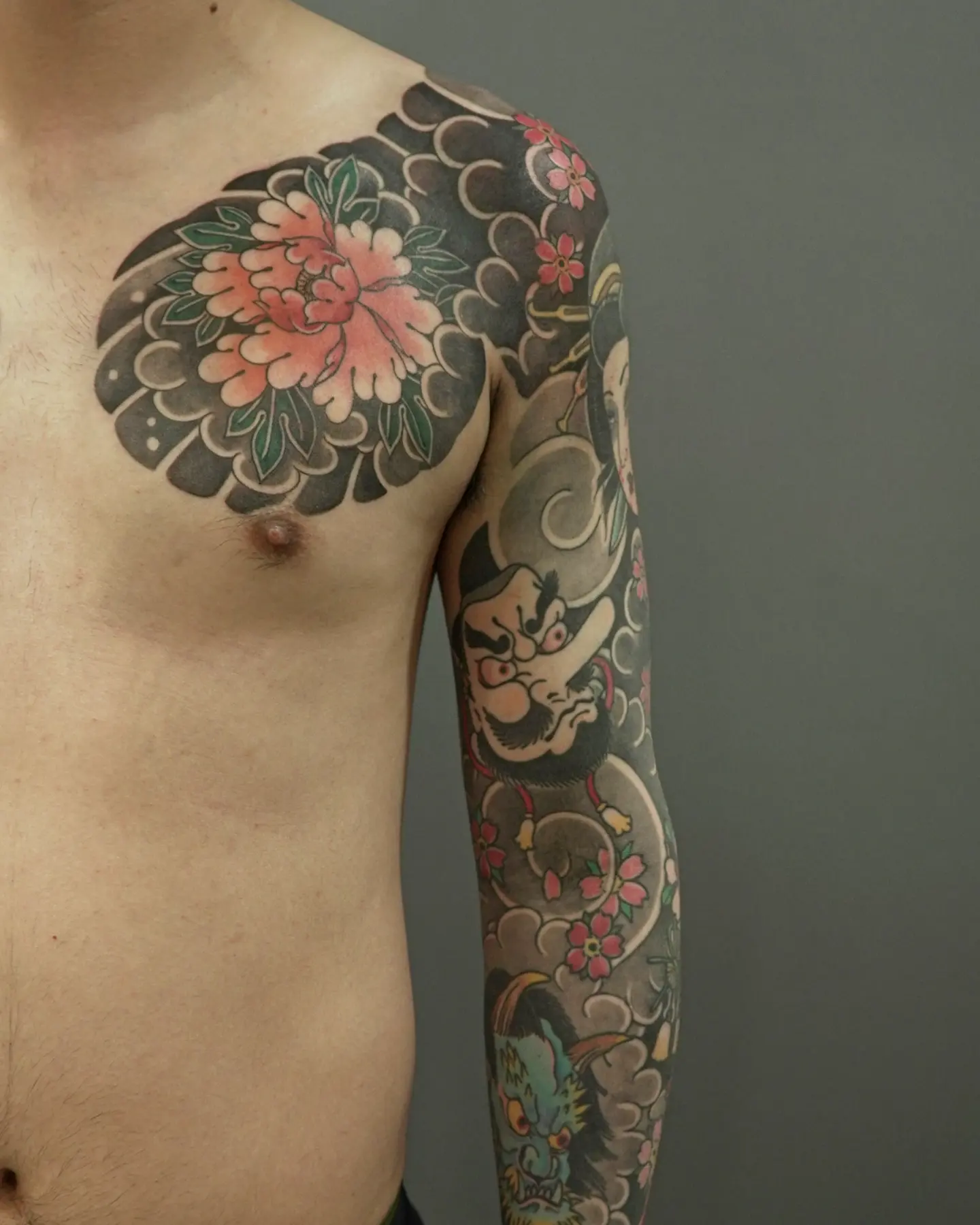 Peony and mask japanese irezumi tattoo on the upper arm by zamix_traditional, San Francisco, California