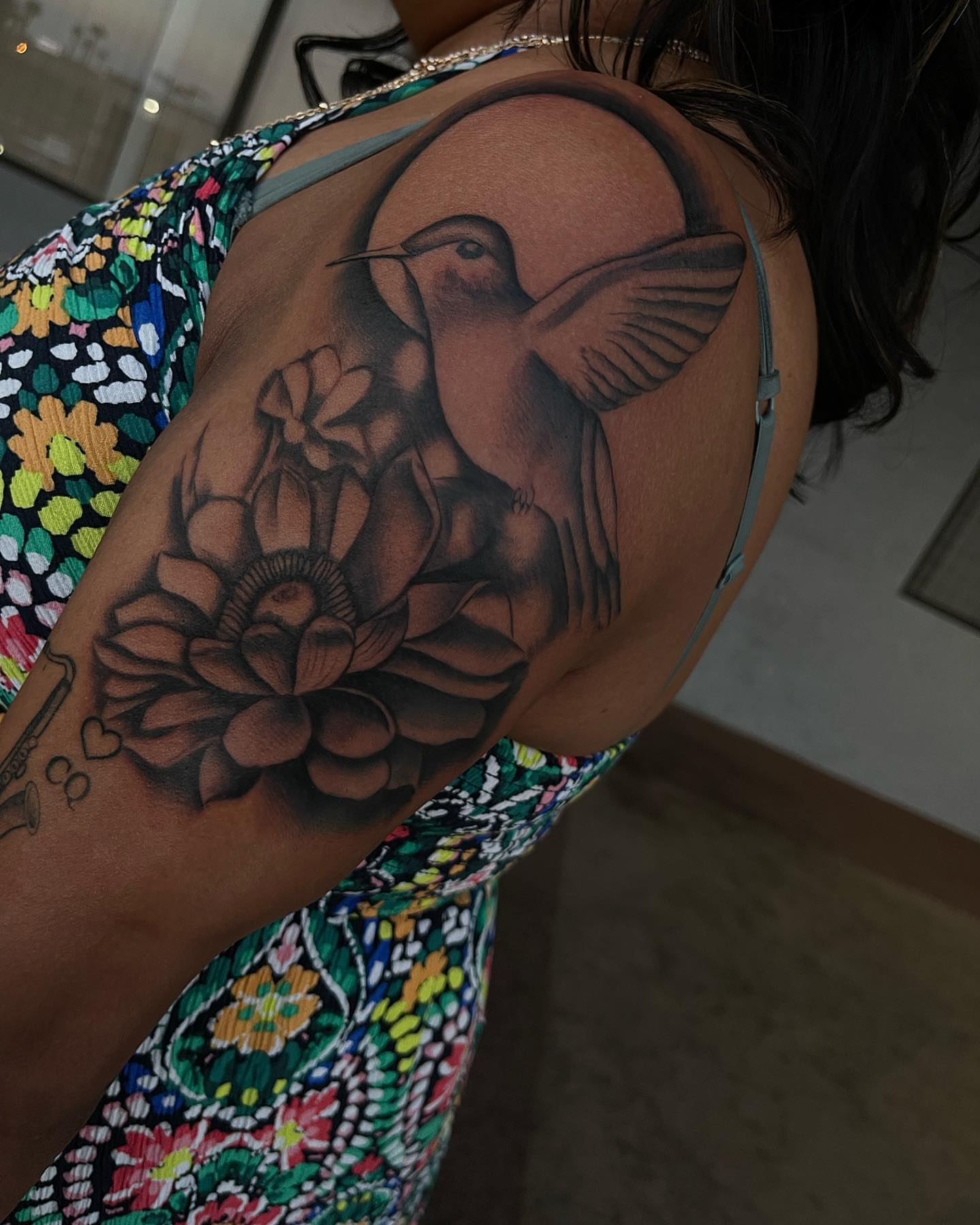 Hummingbird and flower realism tattoo on the shoulder by Las Vegas Tattoo Artist
