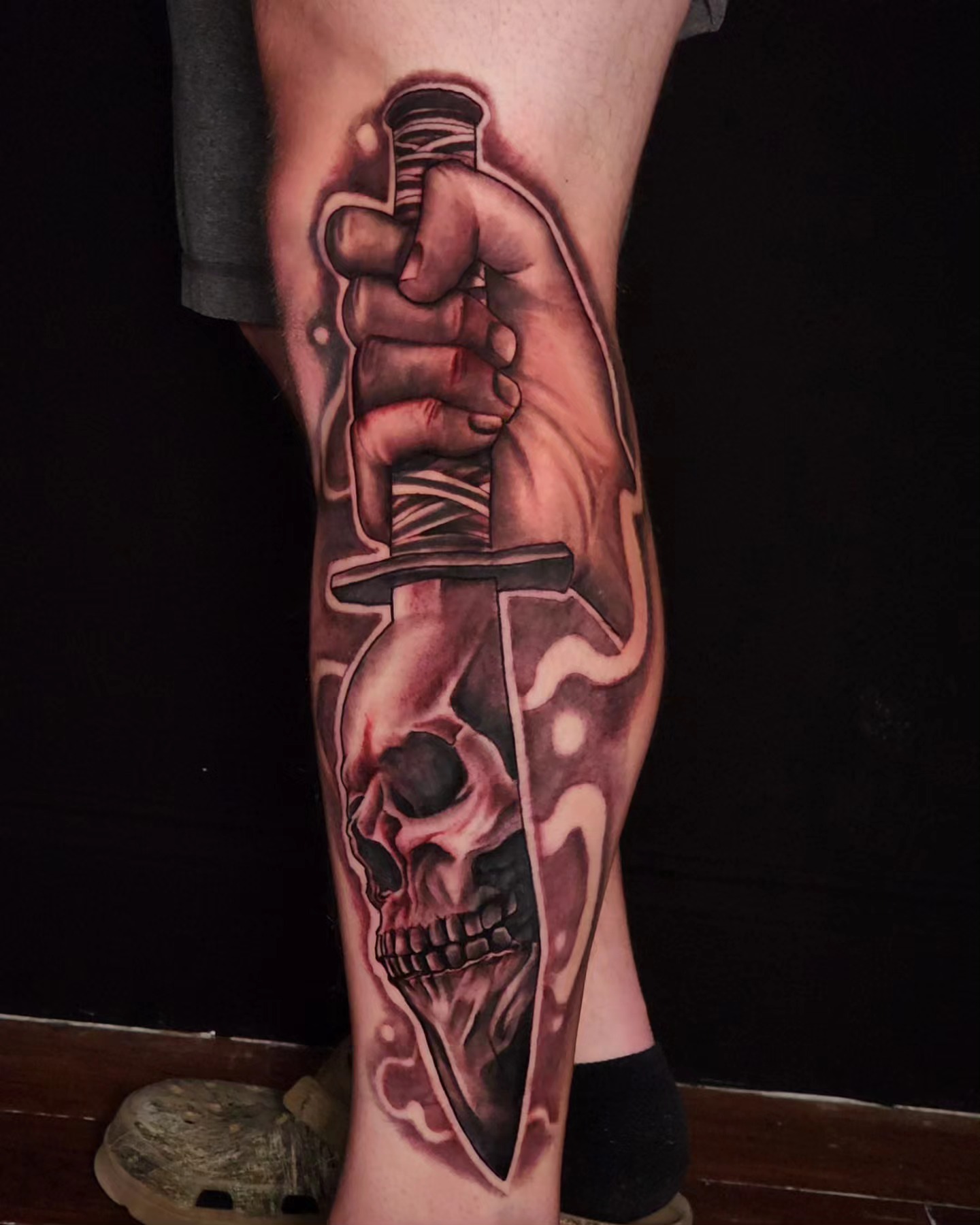 Knife and skull realism tattoo on the calf by Tyler Cromwell