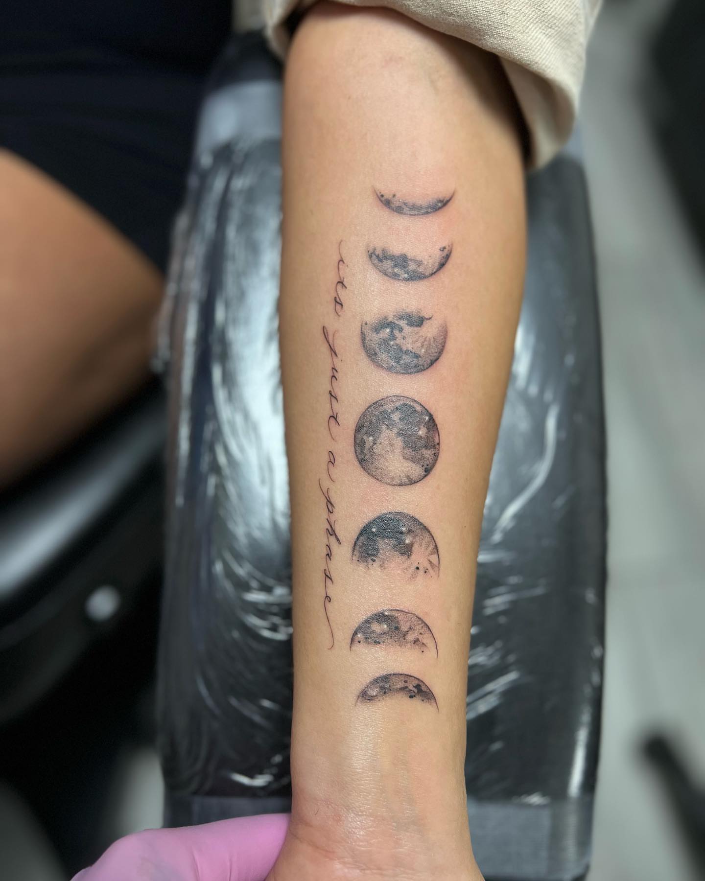 Moon phases black and grey tattoo on the forearm by chris tattoo