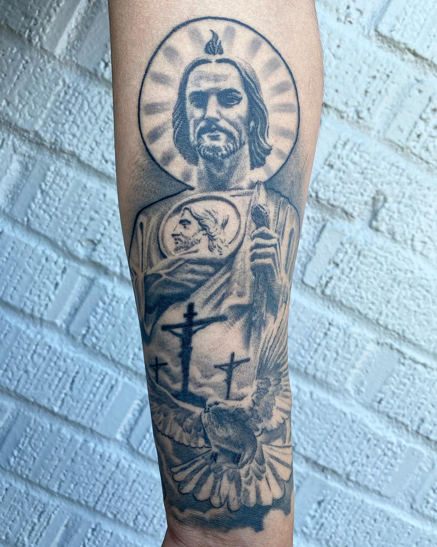 Religious figure black and grey tattoo on the forearm by El Pato, San Jose, California