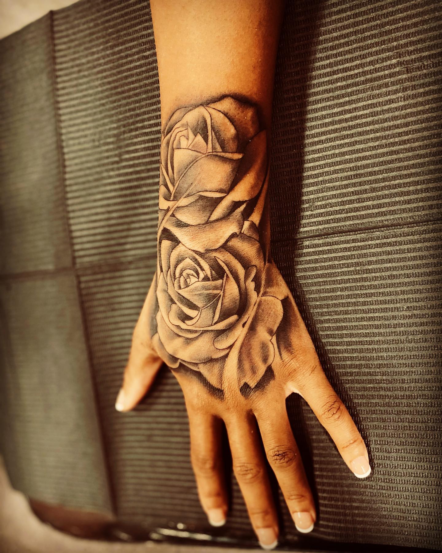 Roses realism tattoo on the hand by Brian Keith