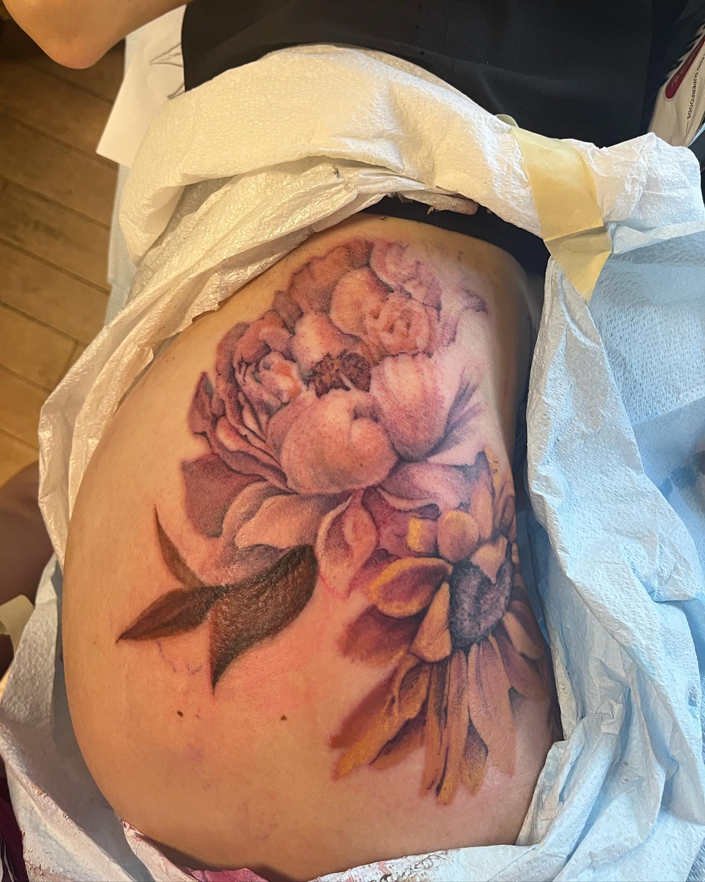 Peony realism tattoo on the thigh by Sarah Spread