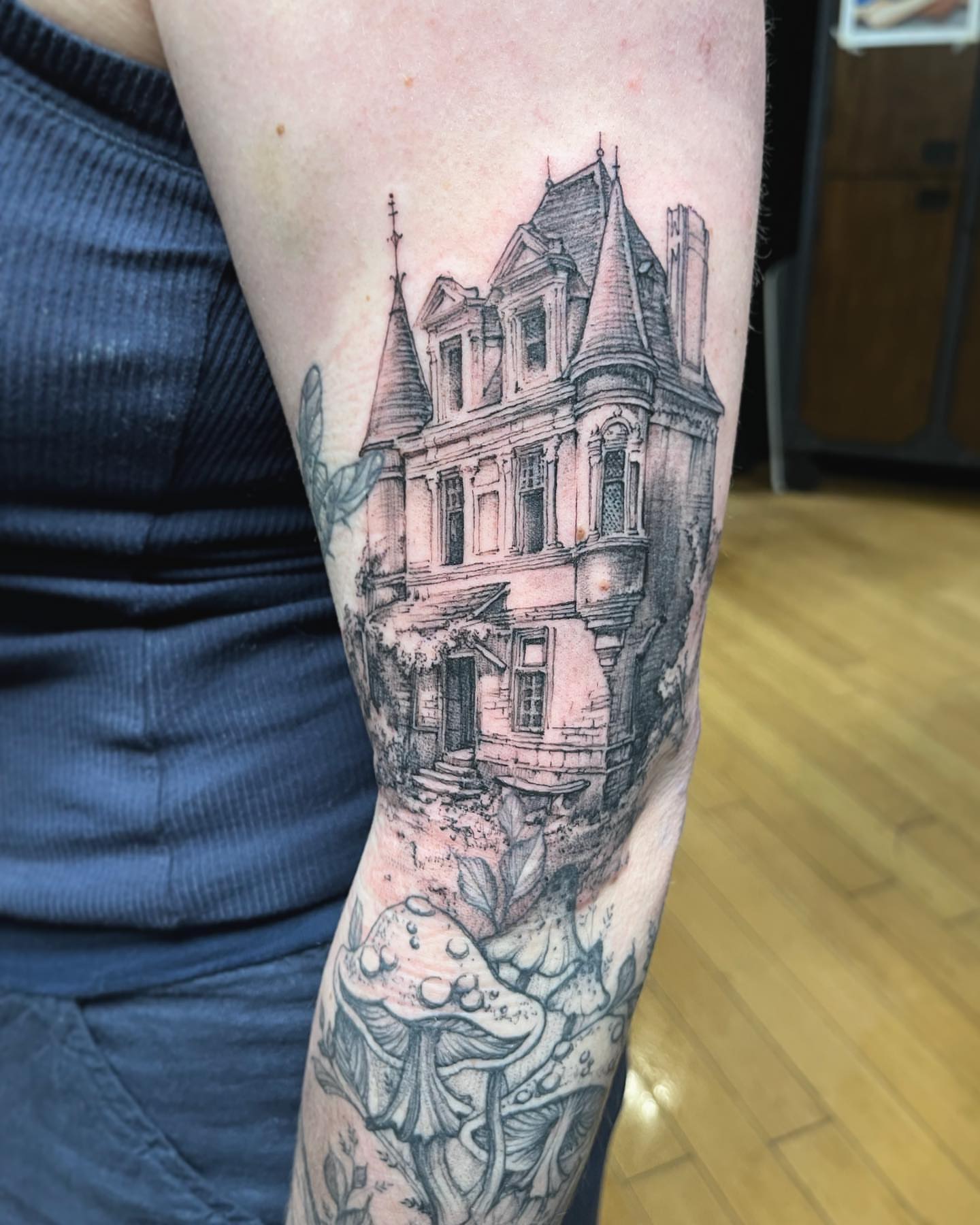 Haunted mansion realism tattoo on the forearm by Sarah Spread