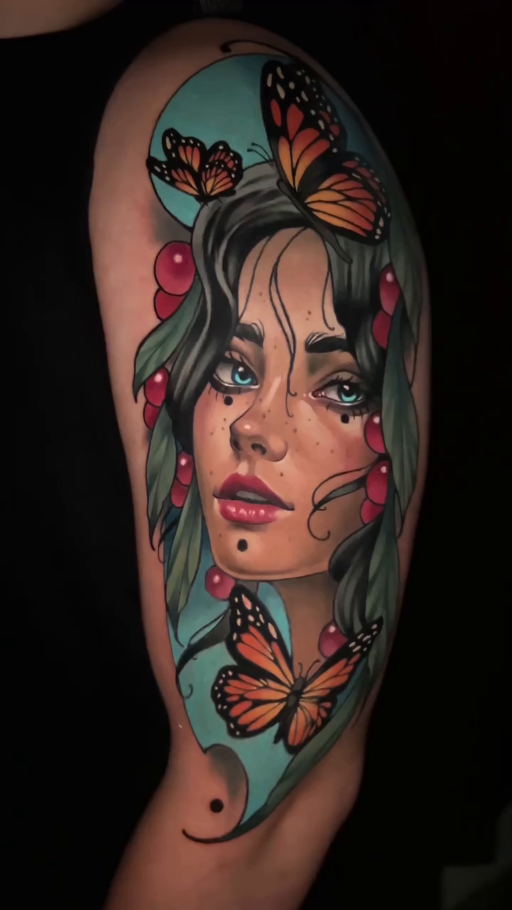 Portrait of a woman with butterflies neo-traditional tattoo on the upper arm by Andrey