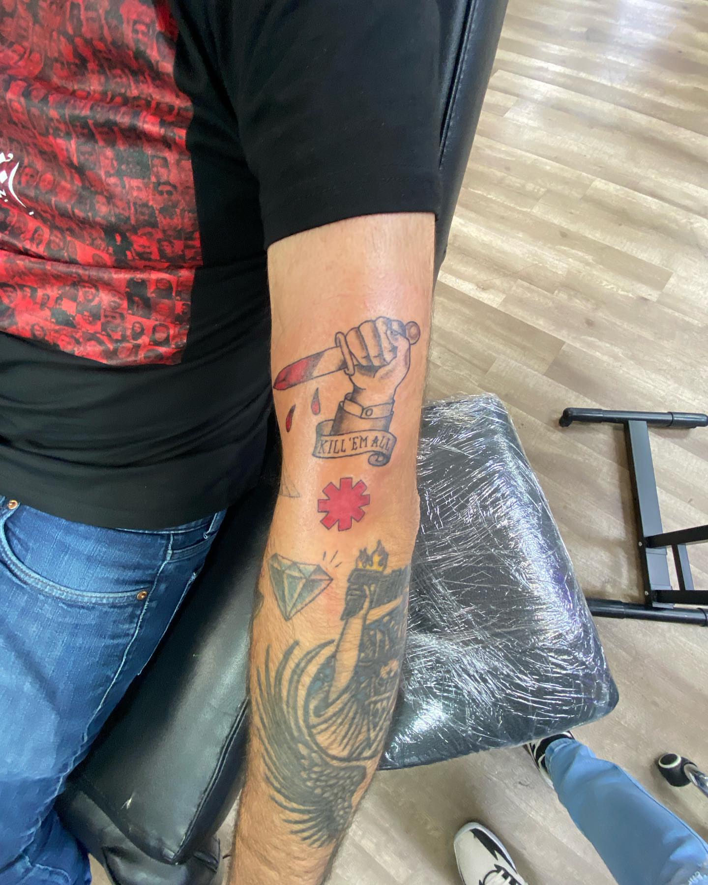 Knife and hand American traditional tattoo on the forearm by Erasmo Vasquez