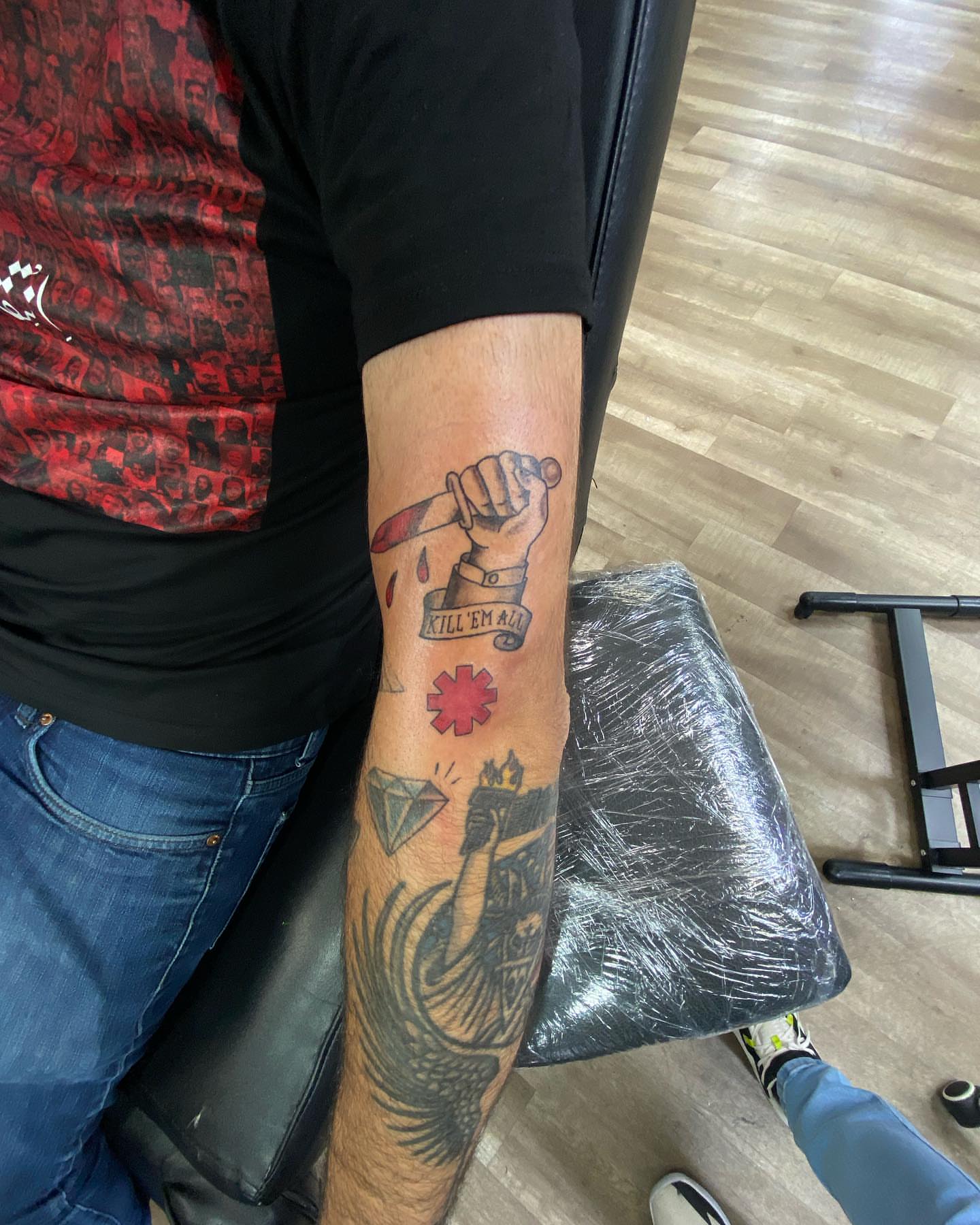 Knife and fist American traditional tattoo on the forearm by Erasmo Vasquez