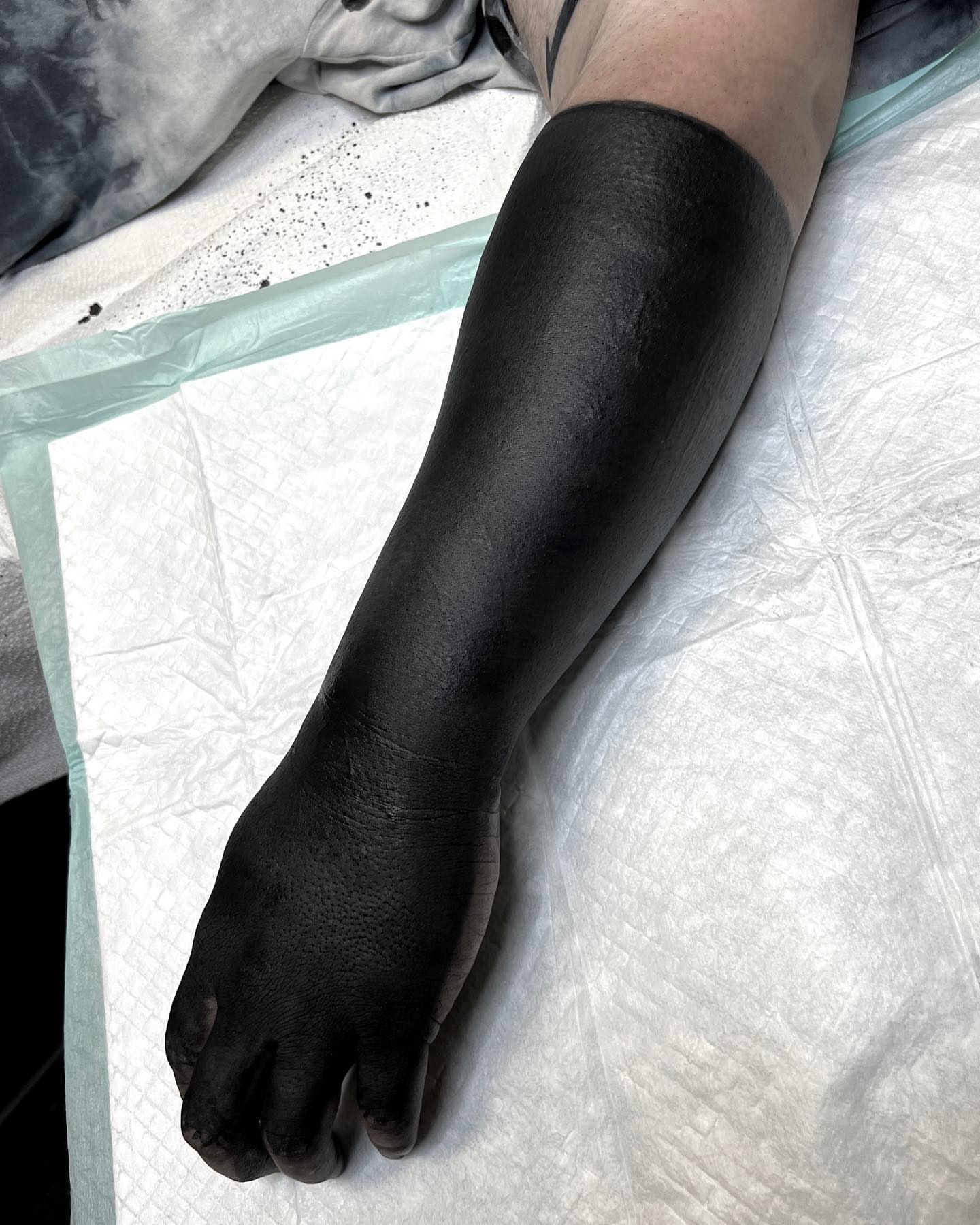 Black sleeve blackwork tattoo on the upper arm by Jon Crook, Portland, Oregon