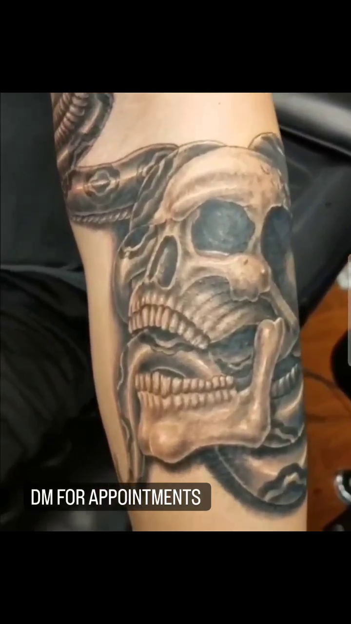 Skull and snake tattoo realism tattoo on the forearm by Jeff Frederick