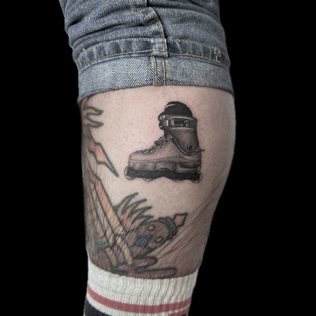 Roller skate and dog black and grey tattoo on the forearm by Blake Owens, Nashville, Tennessee