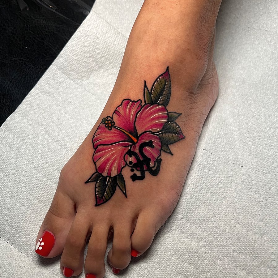 Hibiscus flower American traditional tattoo on the foot by Raul Ortiz