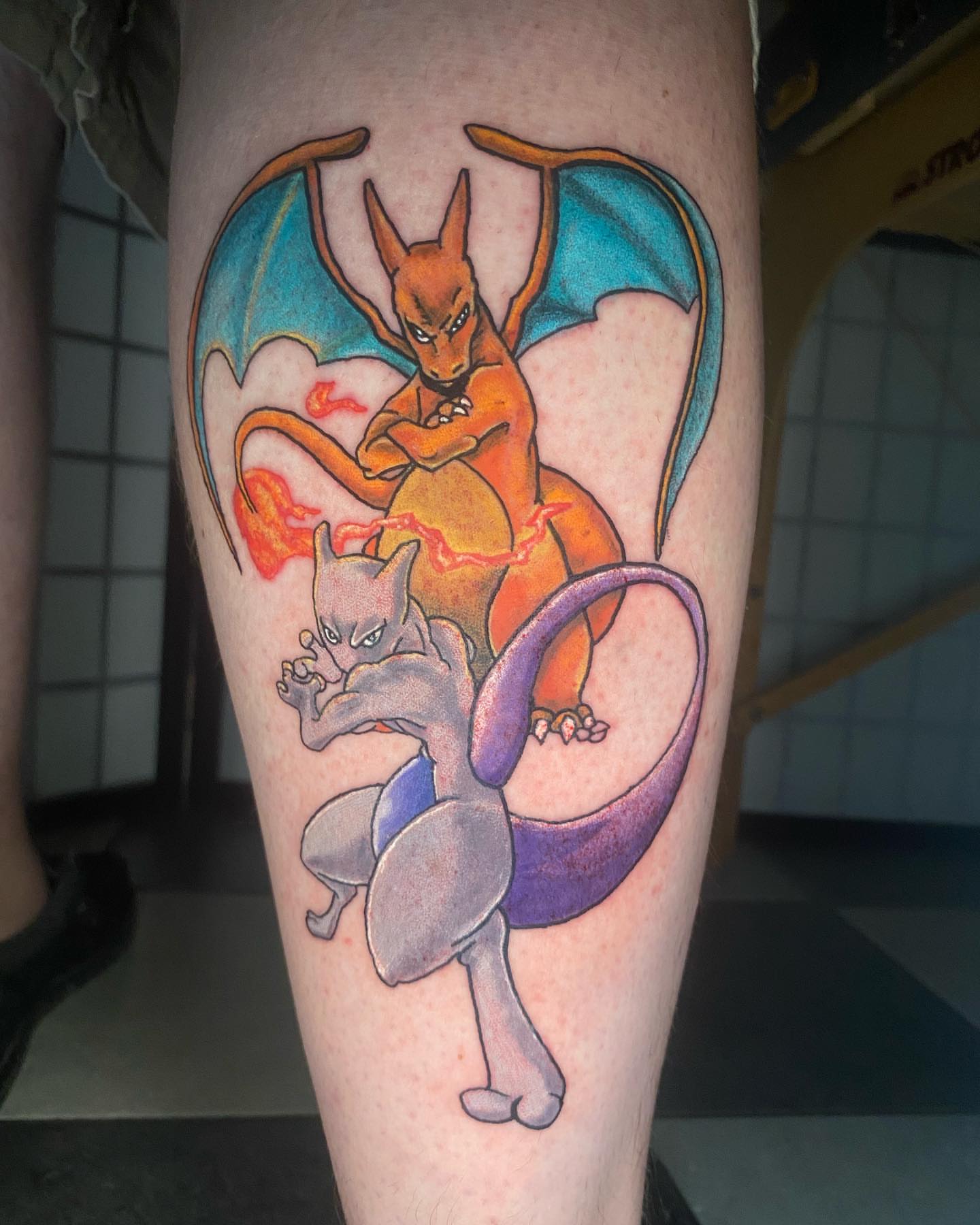 Charizard and mewtwo dotwork tattoo on the thigh by Glen Wallis