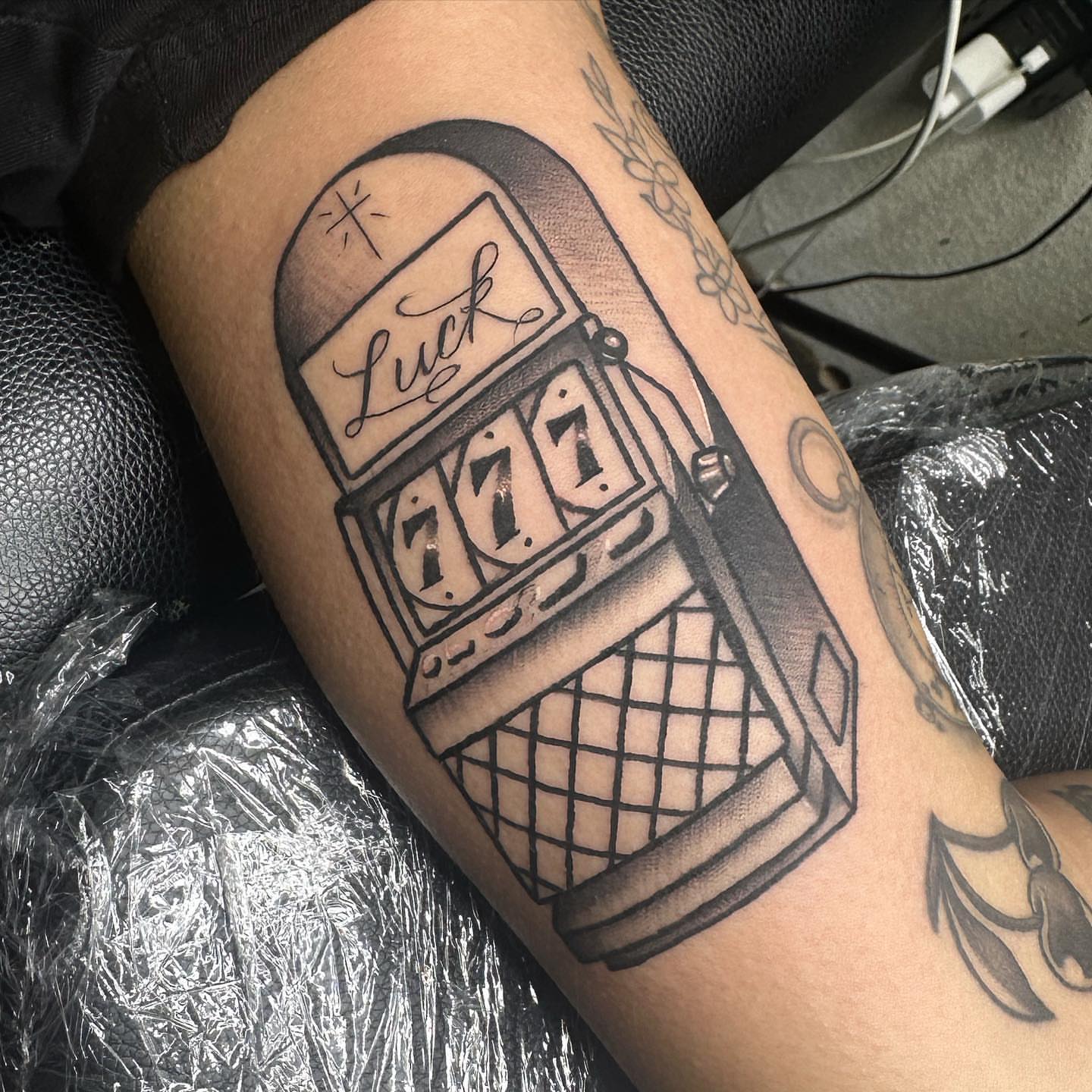 Slot machine black and grey tattoo on the forearm by Tattoosxjoseph