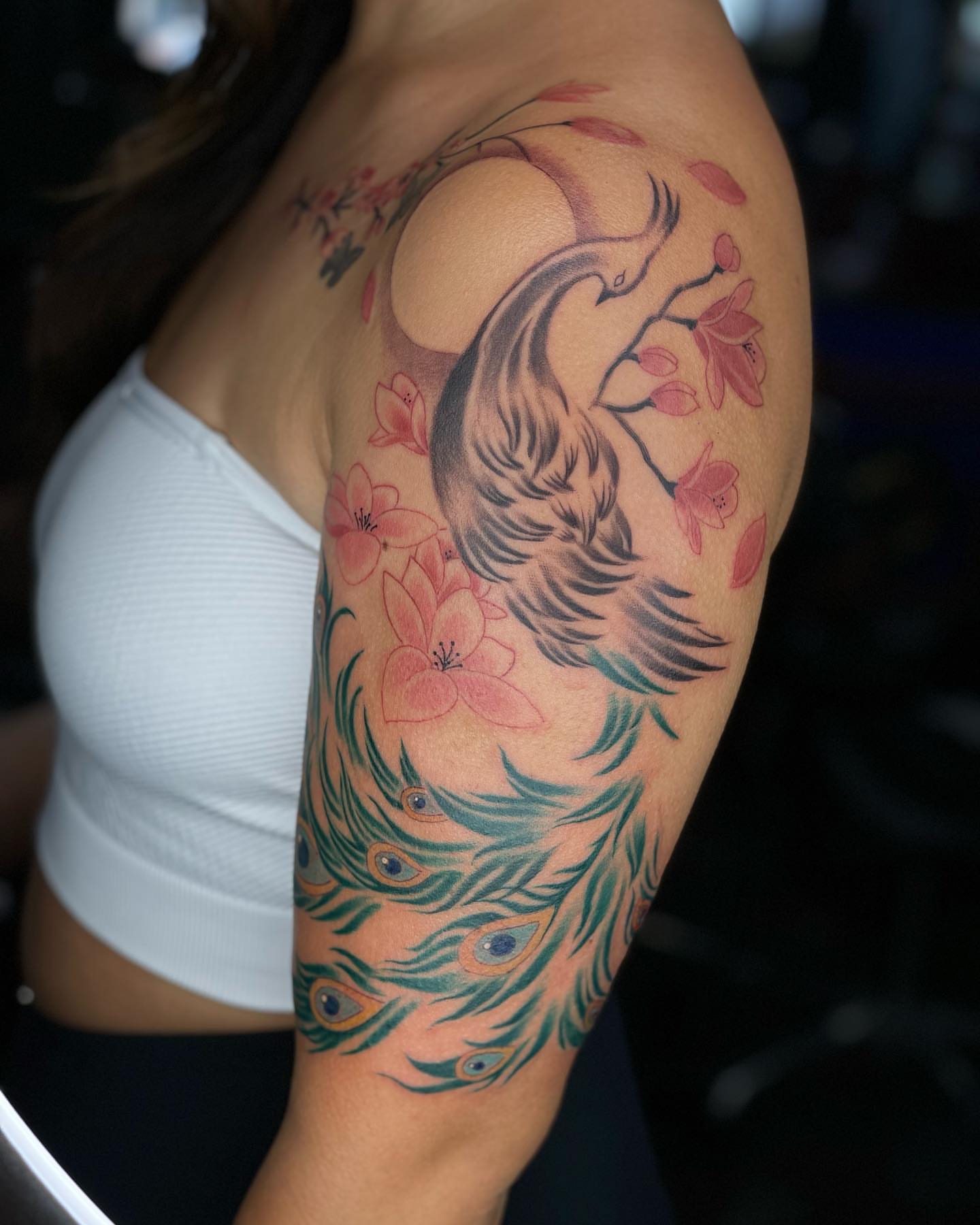 Peacock and cherry blossoms new school tattoo on the shoulder by Tam Nguyen