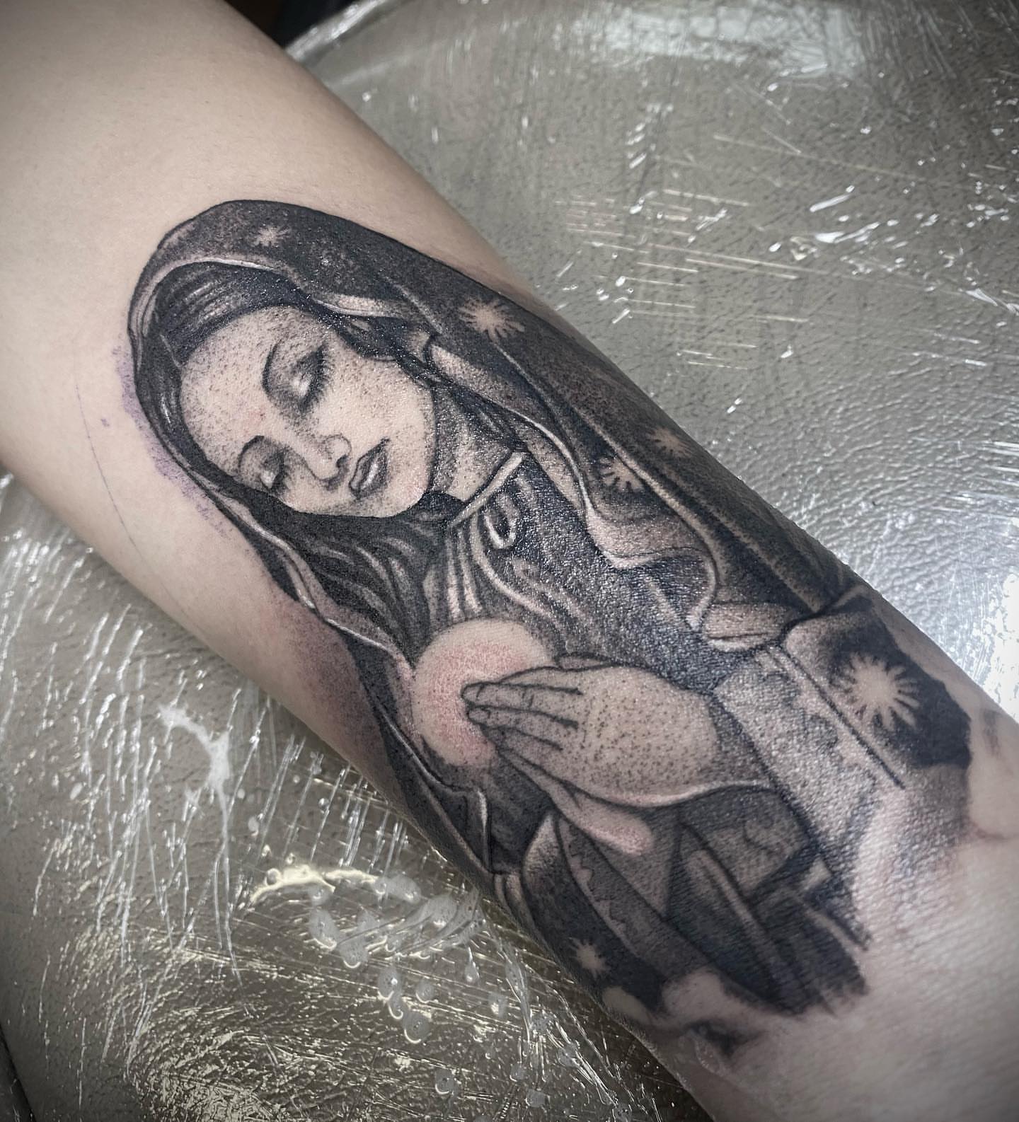 Religious figure dotwork tattoo on the forearm by Angel Rodriguez