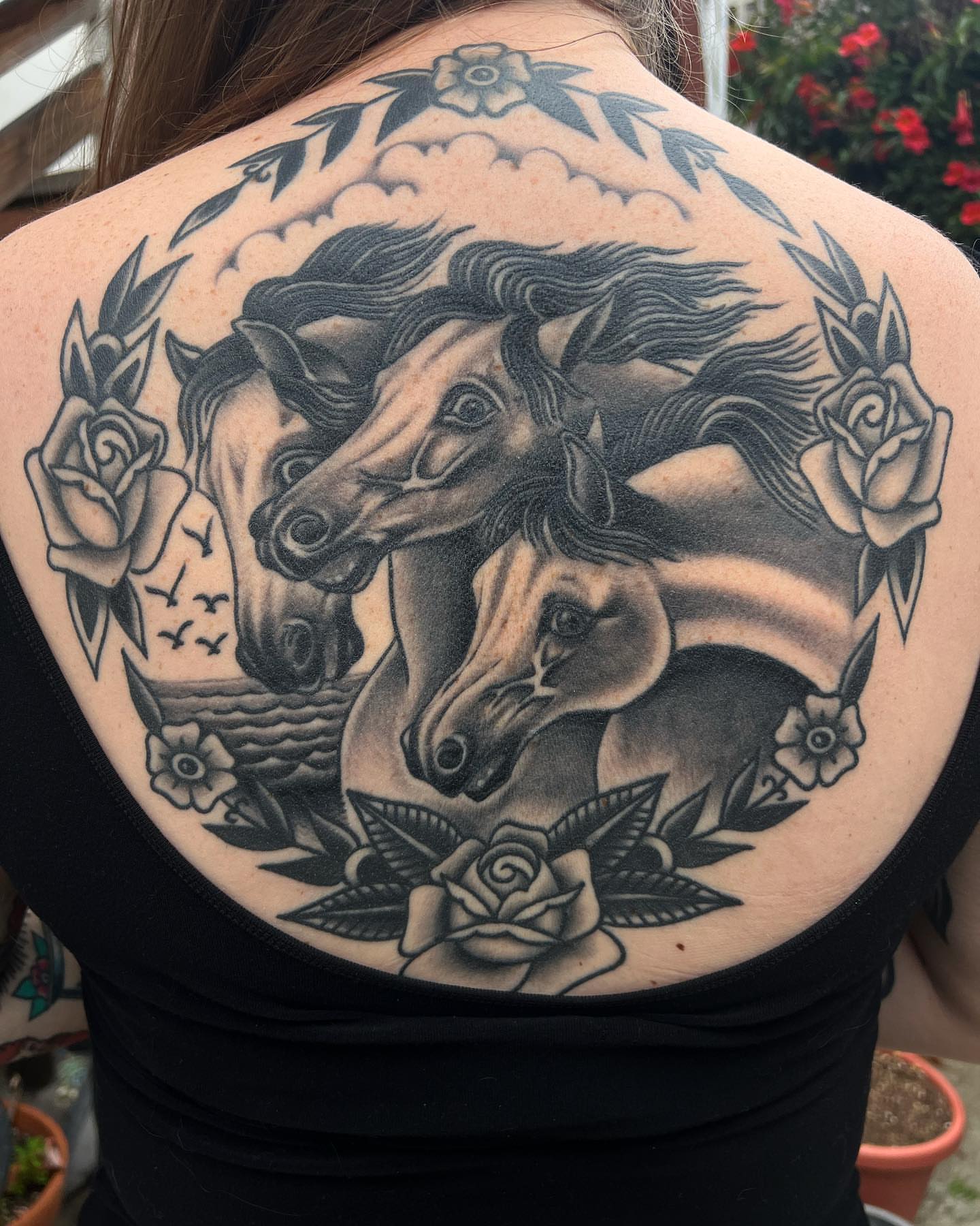 Horses and roses American traditional tattoo on the back by Ross K. Jones Tattoos, San Francisco, California