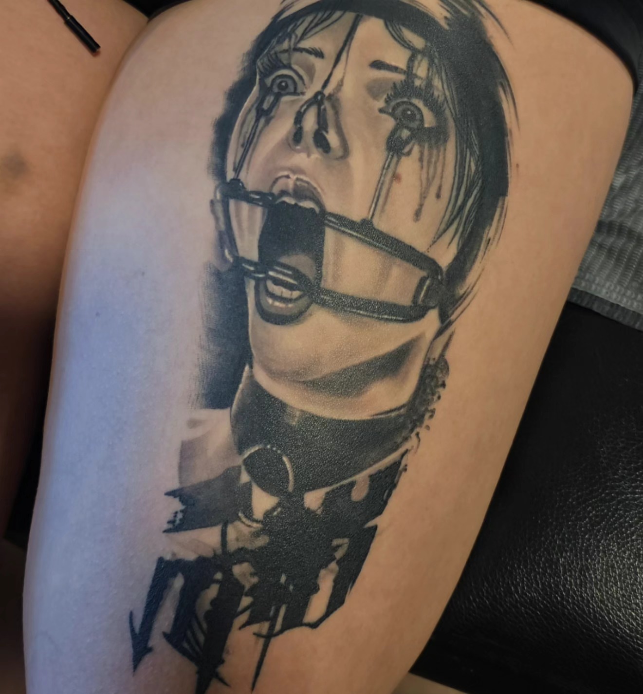 Woman gagged realism tattoo on the thigh by Christian Mulvey