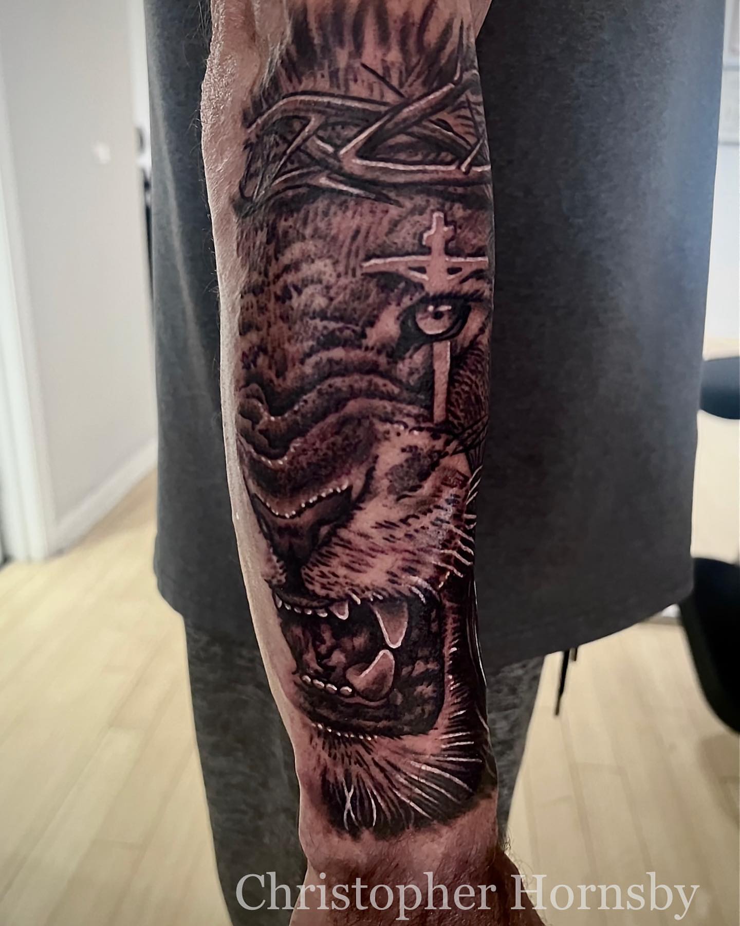 Lion realism tattoo on the forearm by Chris Hornsby