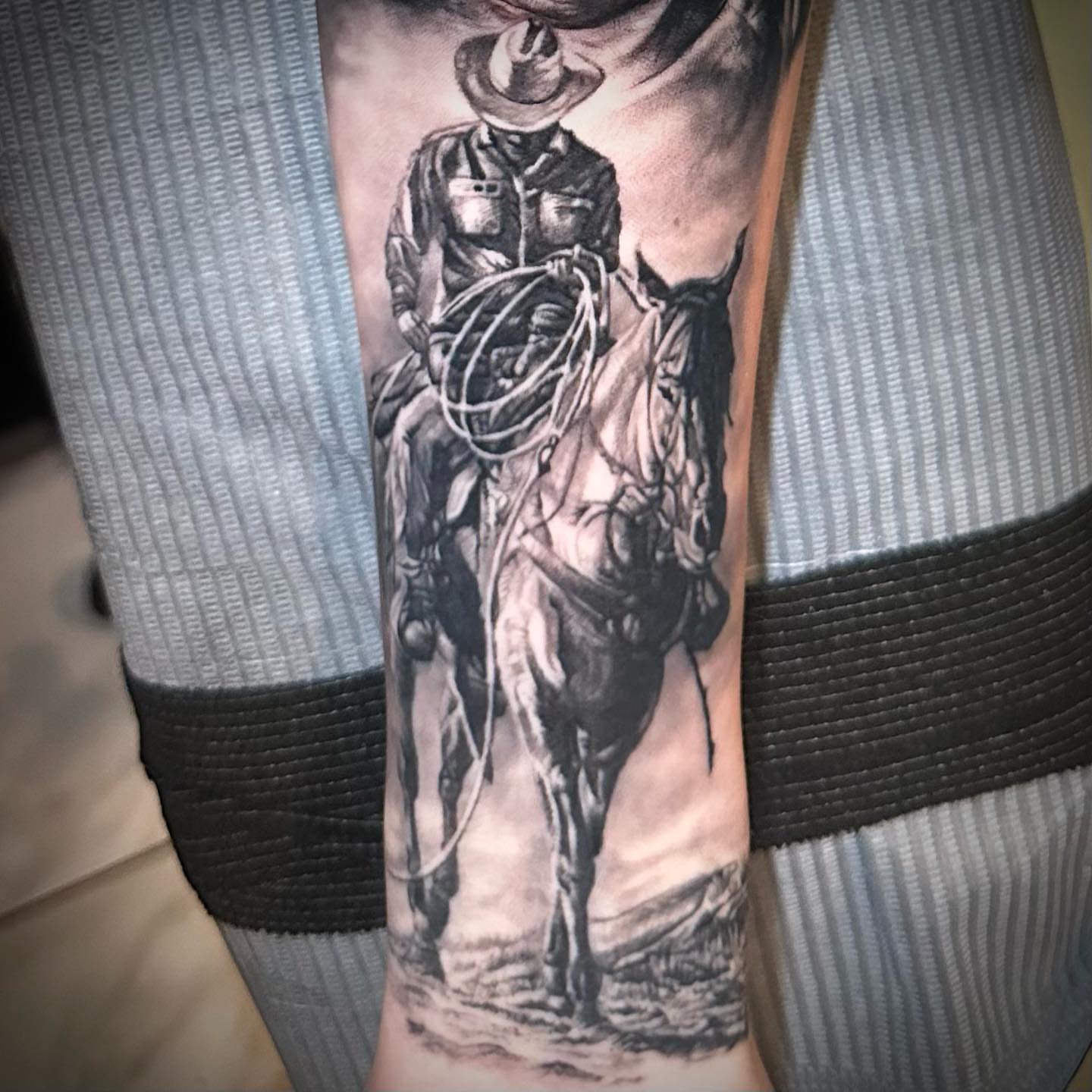 Cowboy on horse realism tattoo on the forearm by Chrisjansentattoo