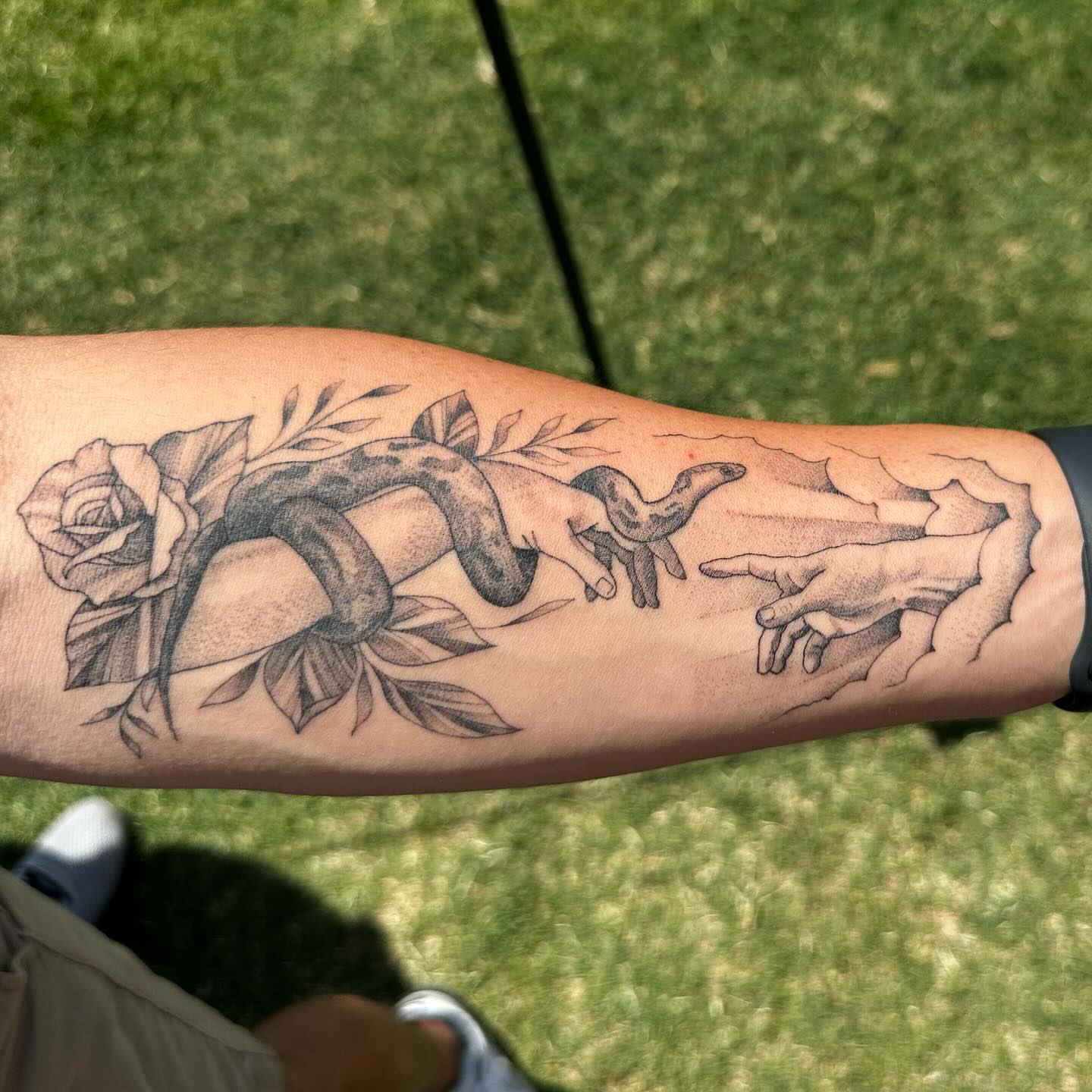 Snake and peony realism tattoo on the forearm by Raul Najera Tattoo, Plano, Texas
