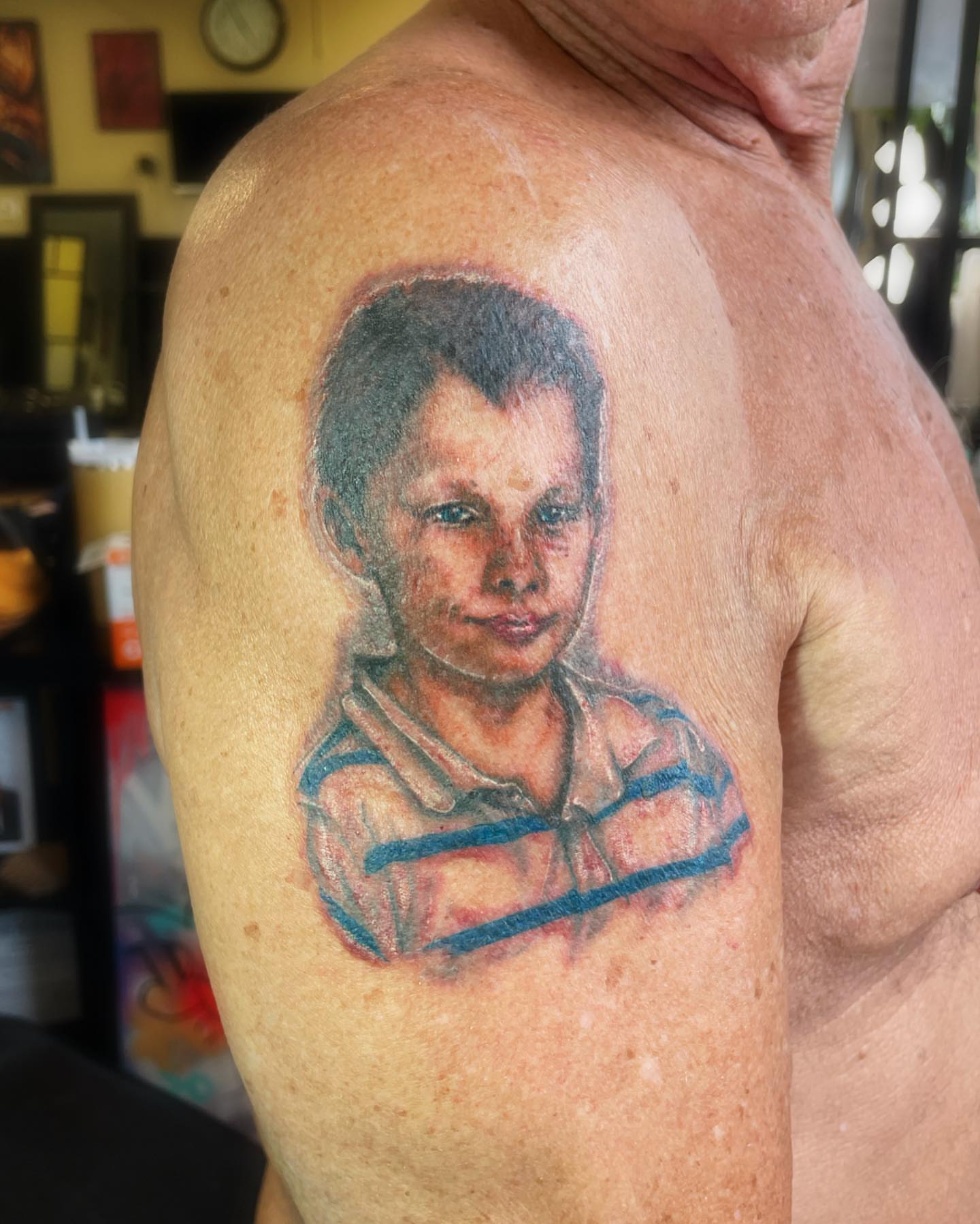 Child portrait realism tattoo on the shoulder by Brookelyn